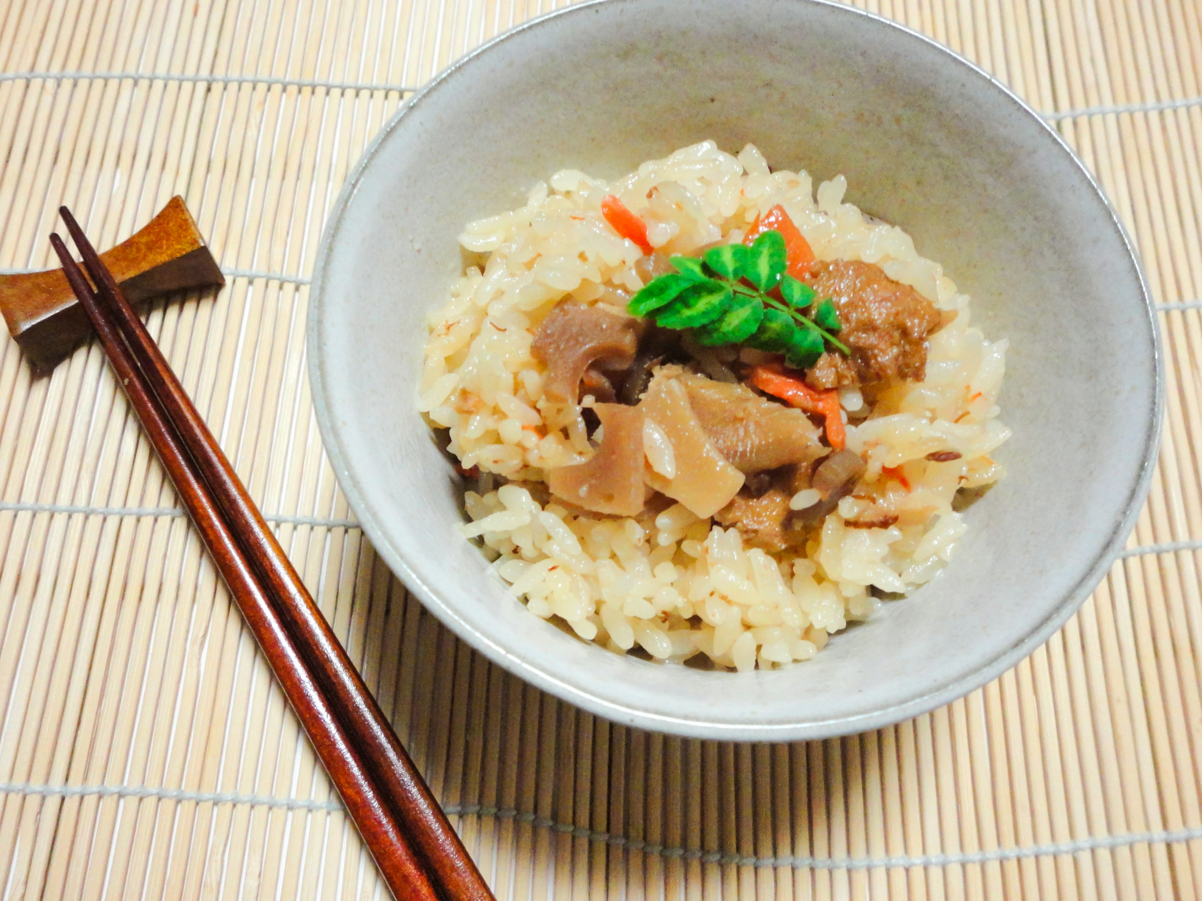 Bowl of rice topped with meat and vegetables in a Japanese style