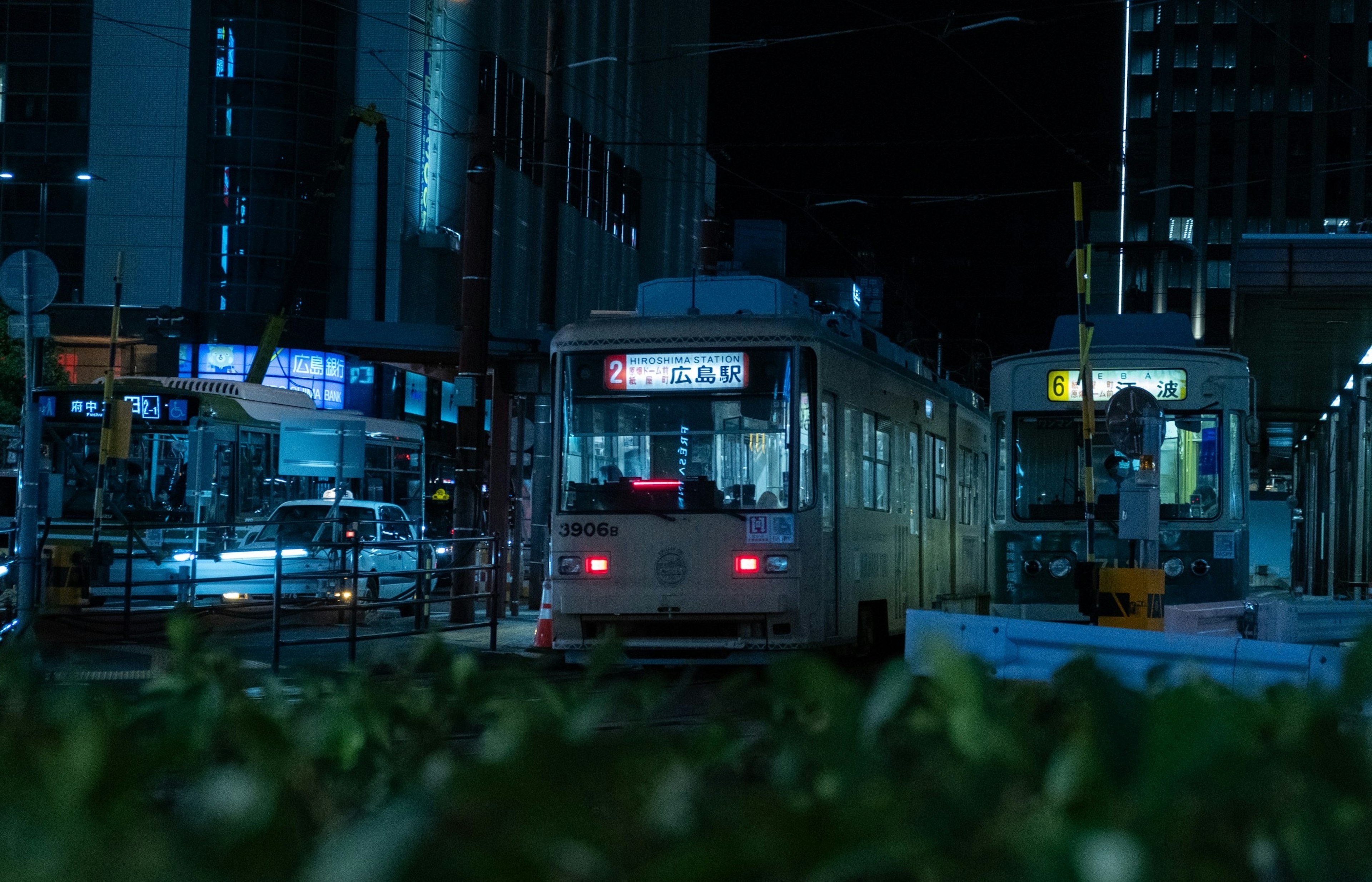 Tram in a night city scene with illuminated buildings