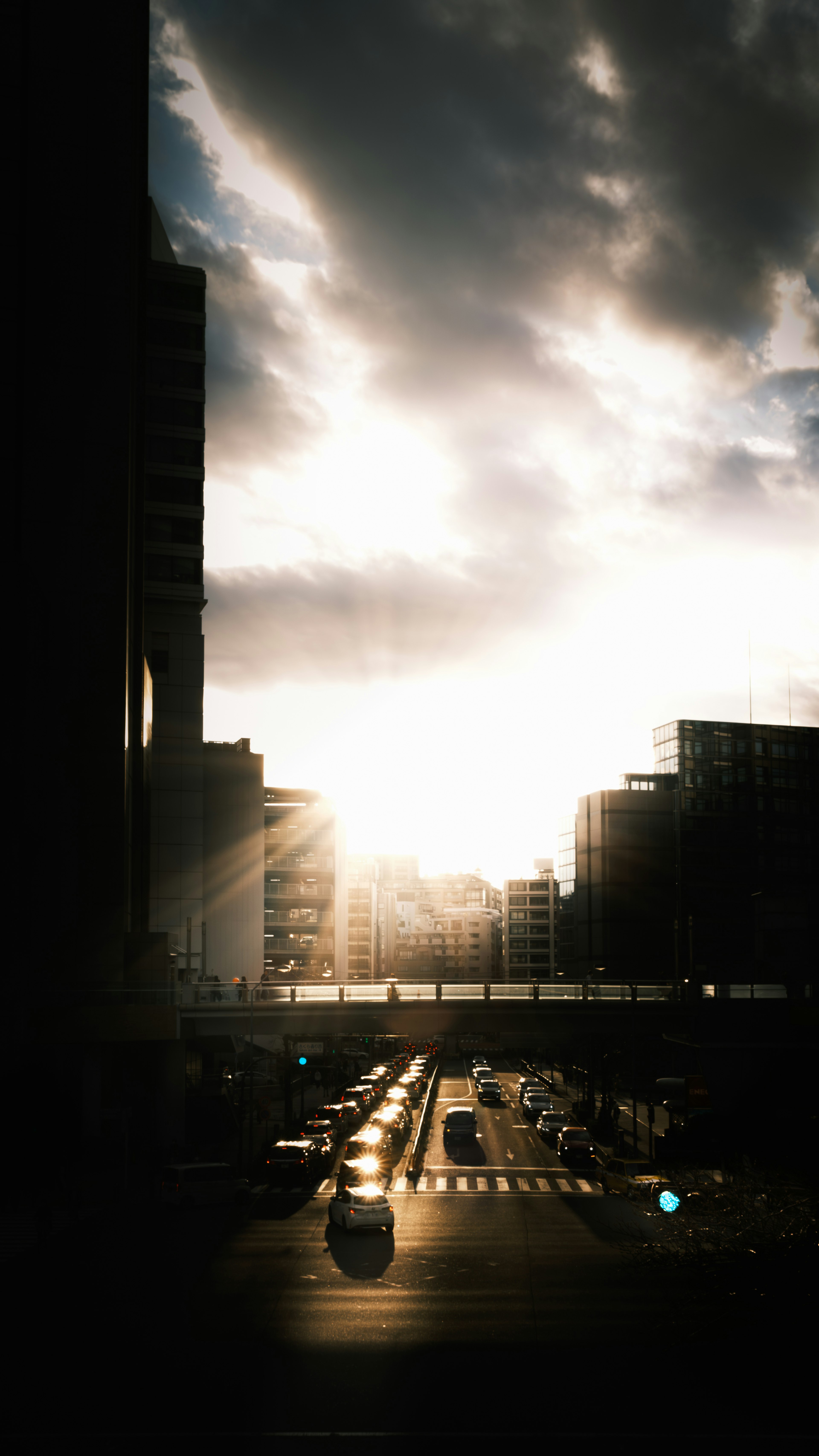 Urban landscape with sunset visible between buildings