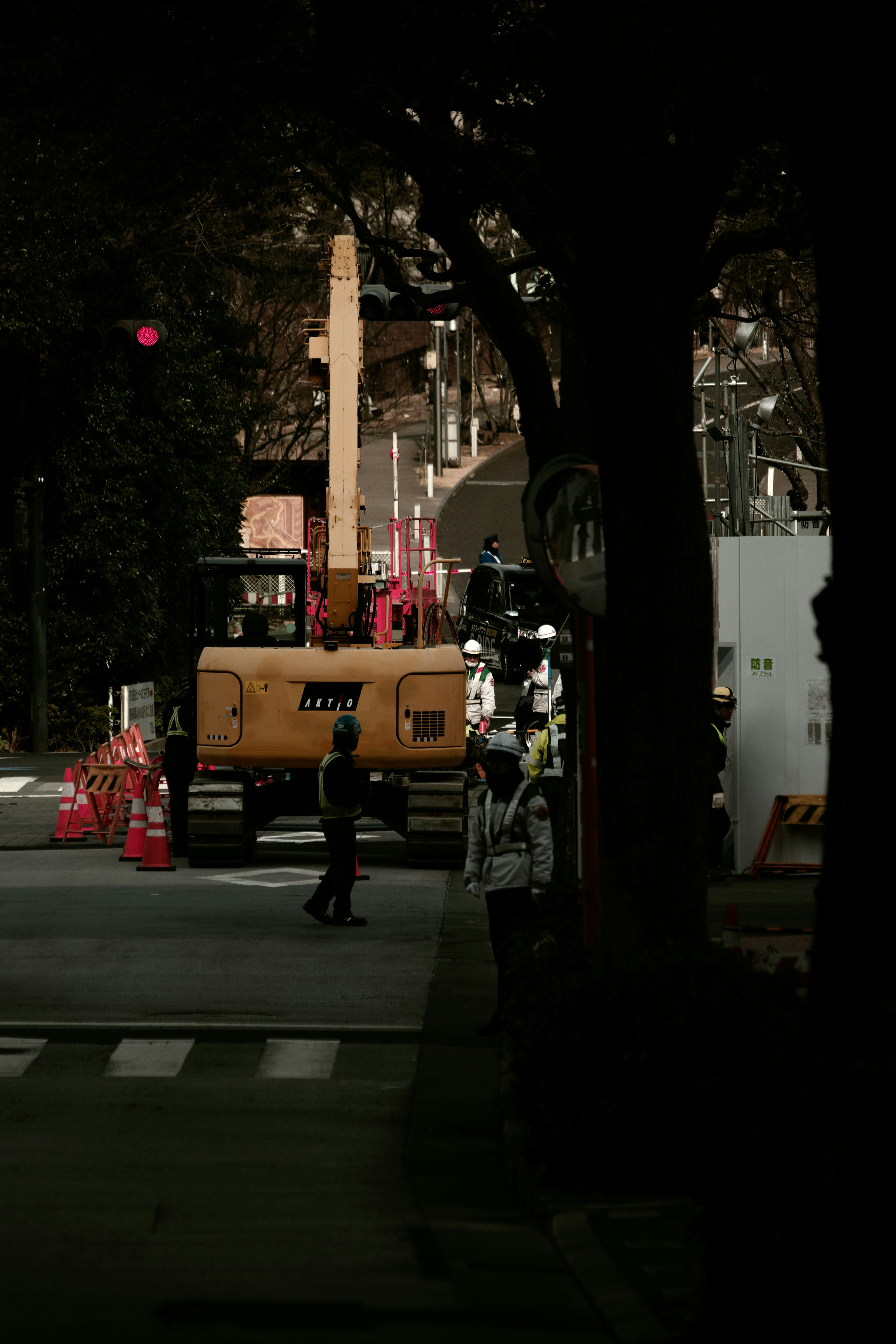 Construction site with heavy machinery and workers on the street