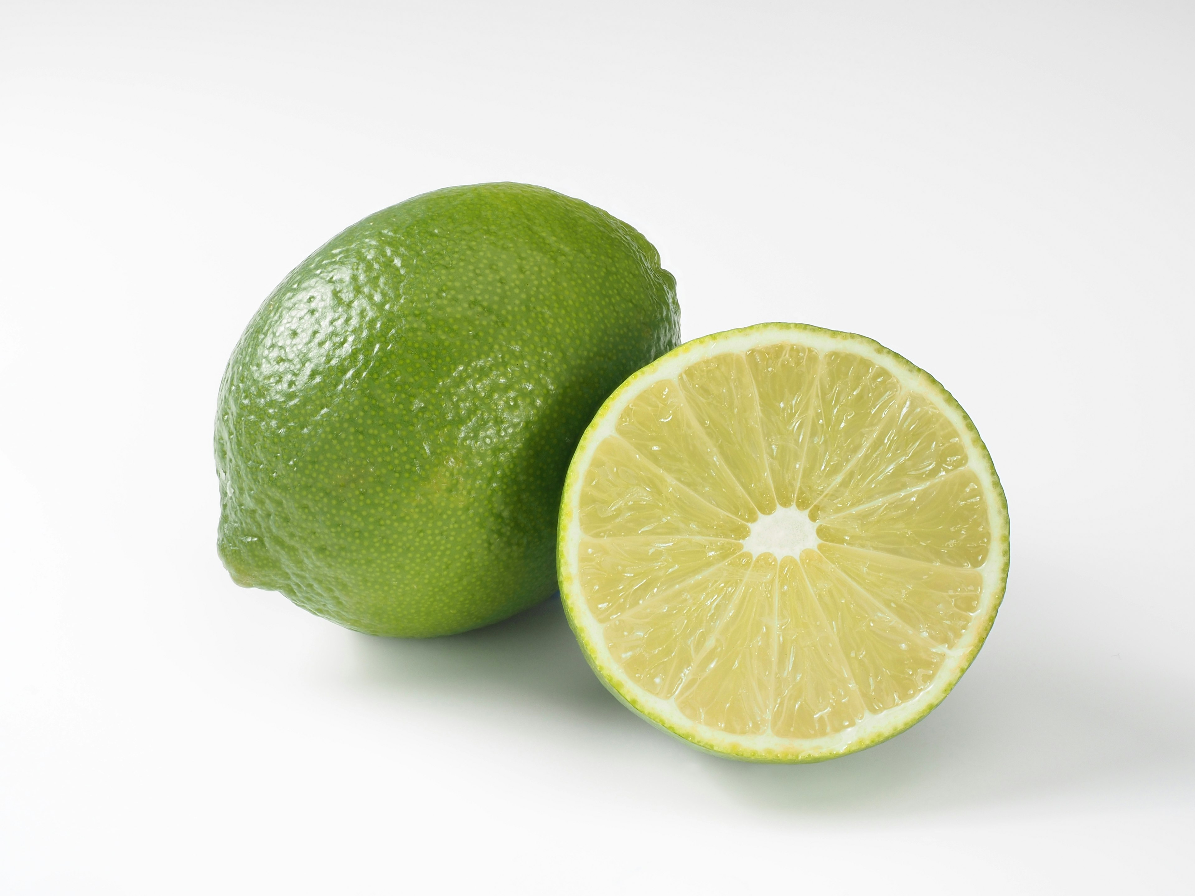 Whole lime and a halved lime showing the inside