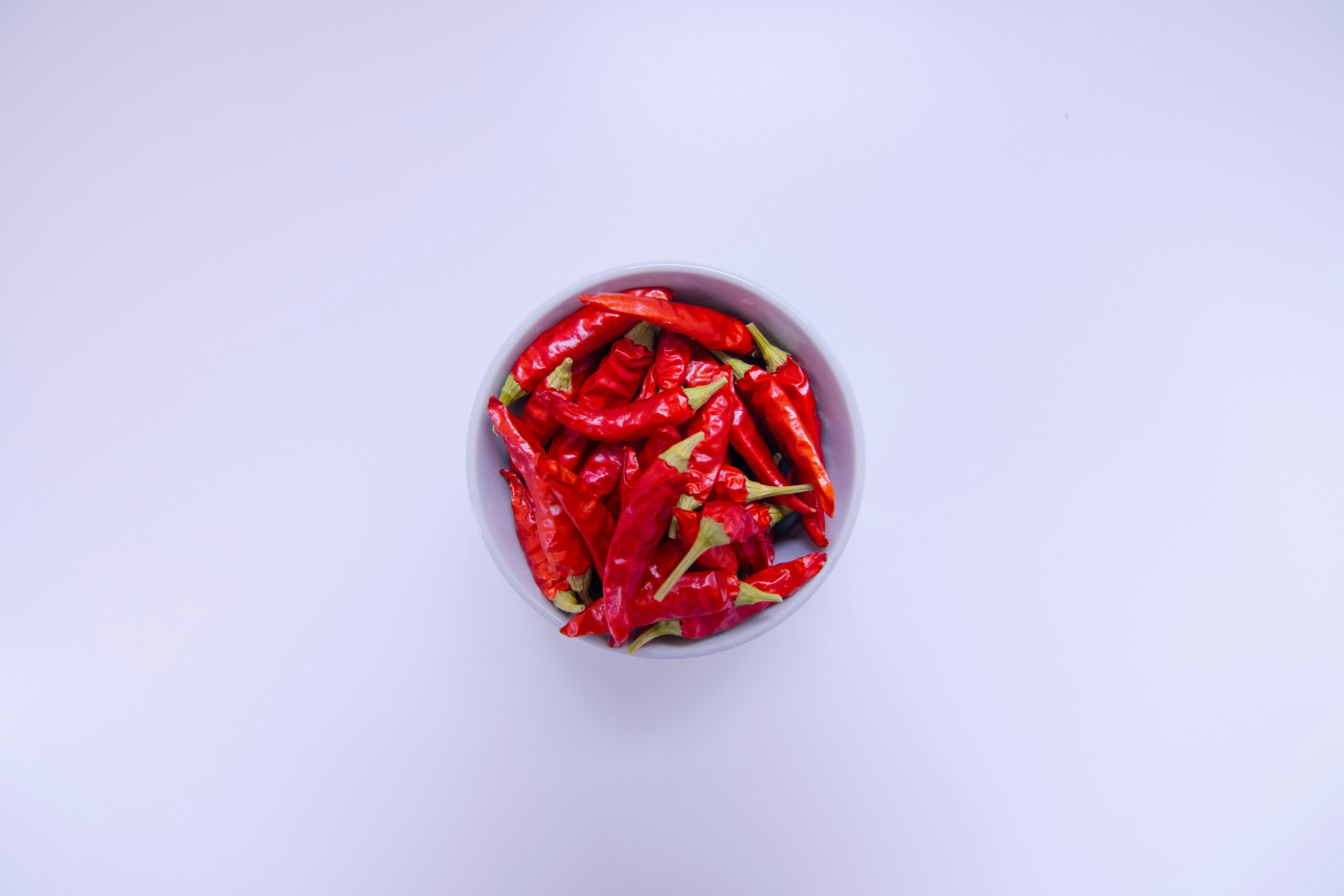 A bowl of red chili peppers viewed from above