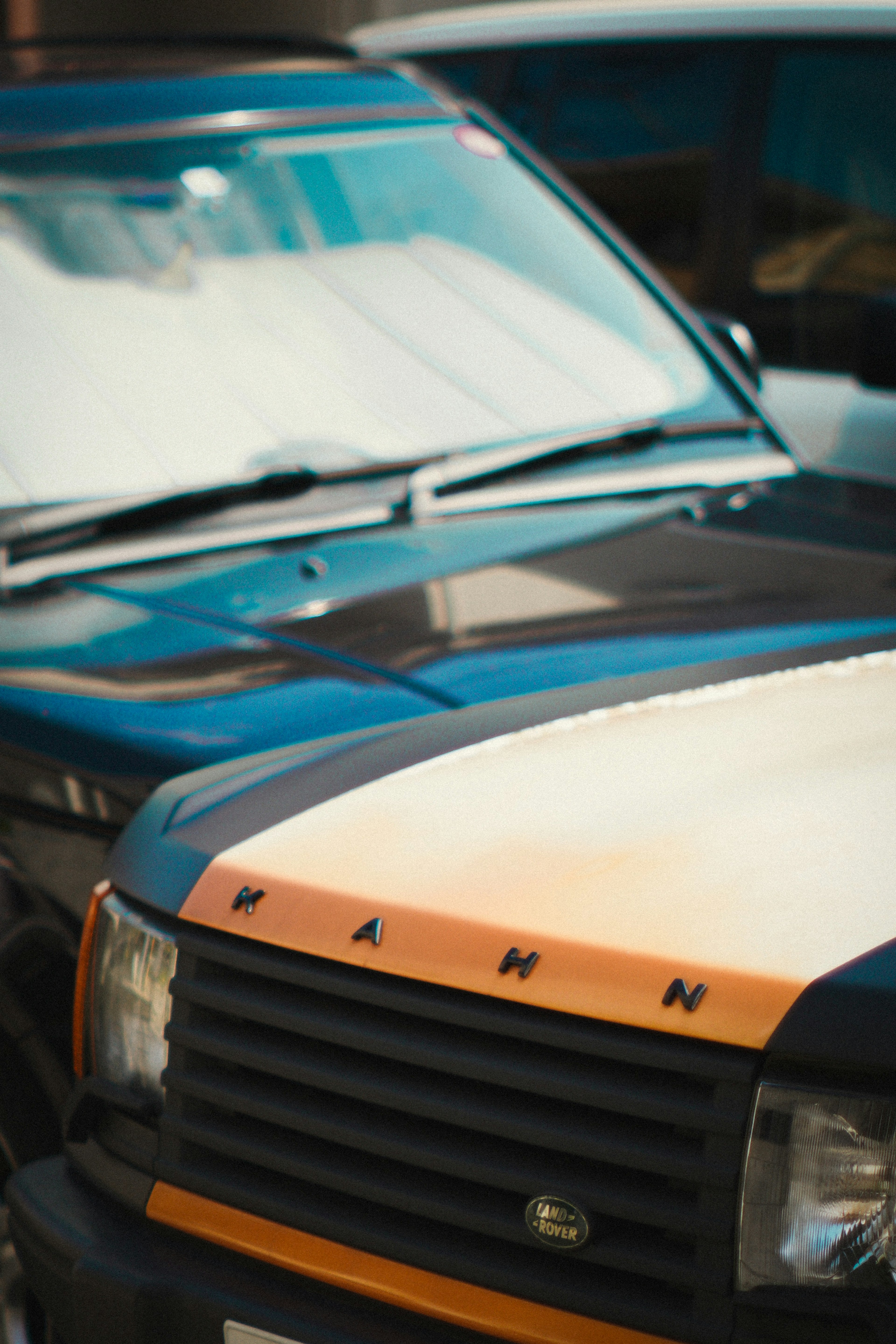 Front view of a car featuring distinctive blue and orange stripes