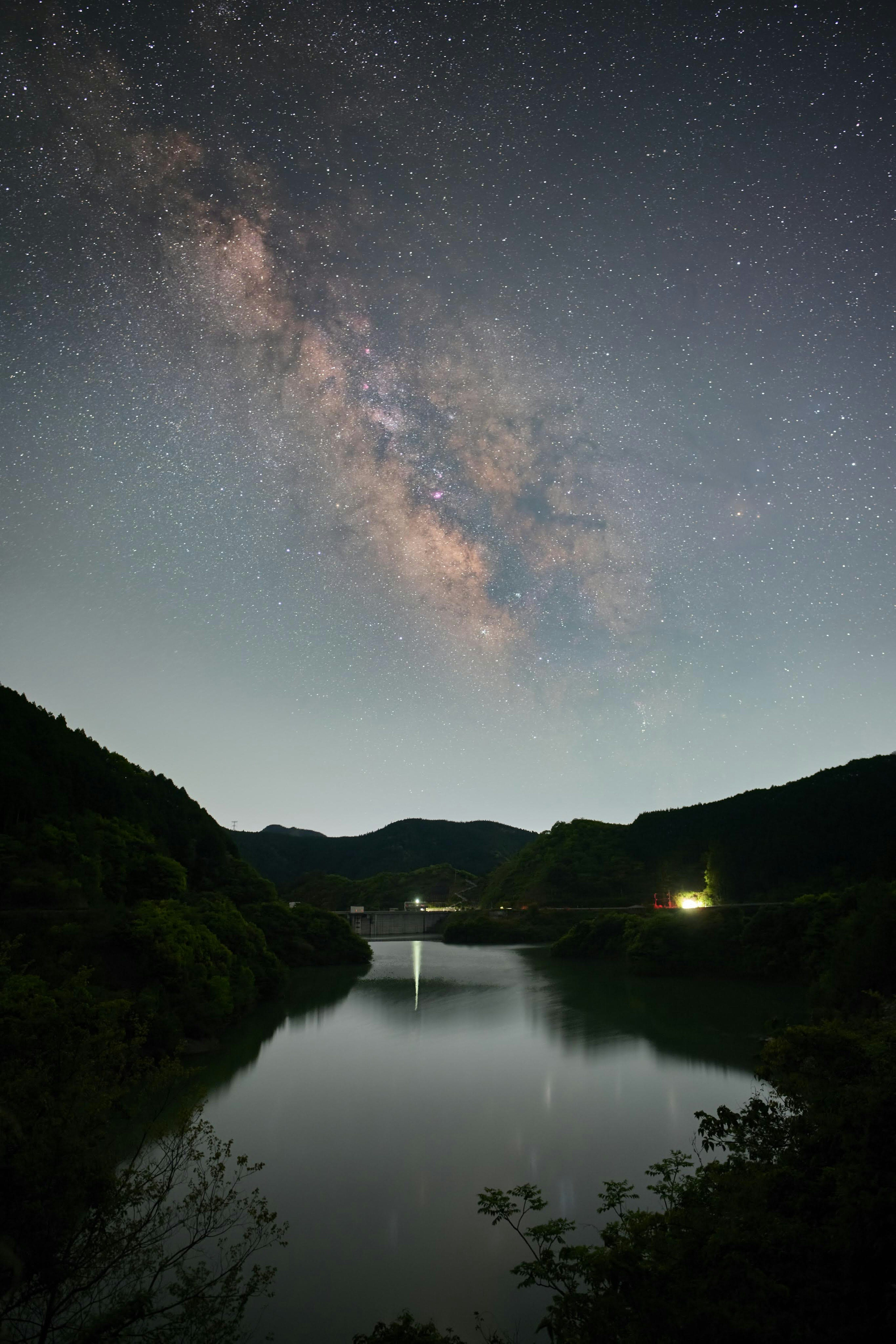 Tranquil lake and mountains under a starry sky