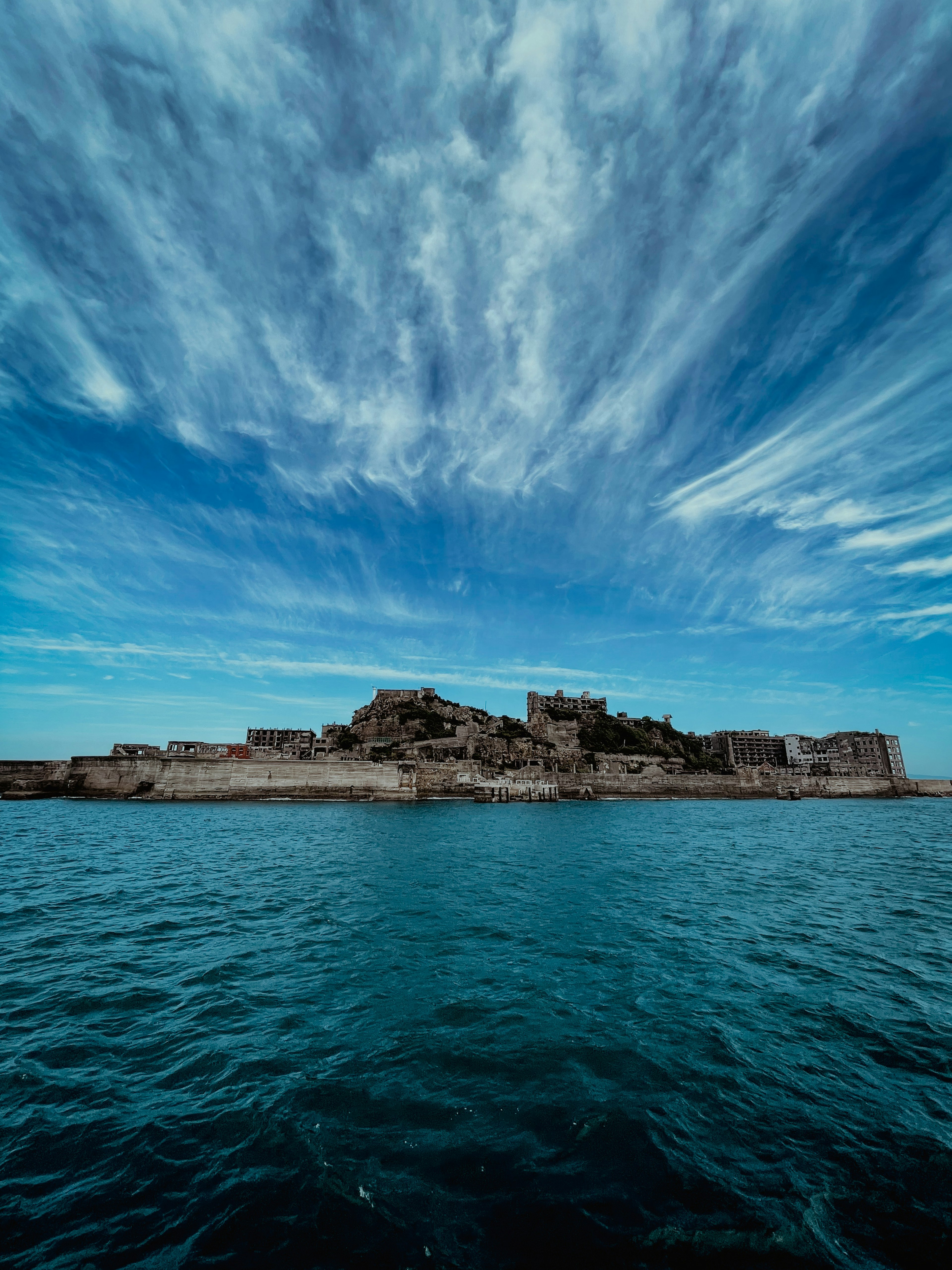 Medieval castle surrounded by blue sea and beautiful clouds