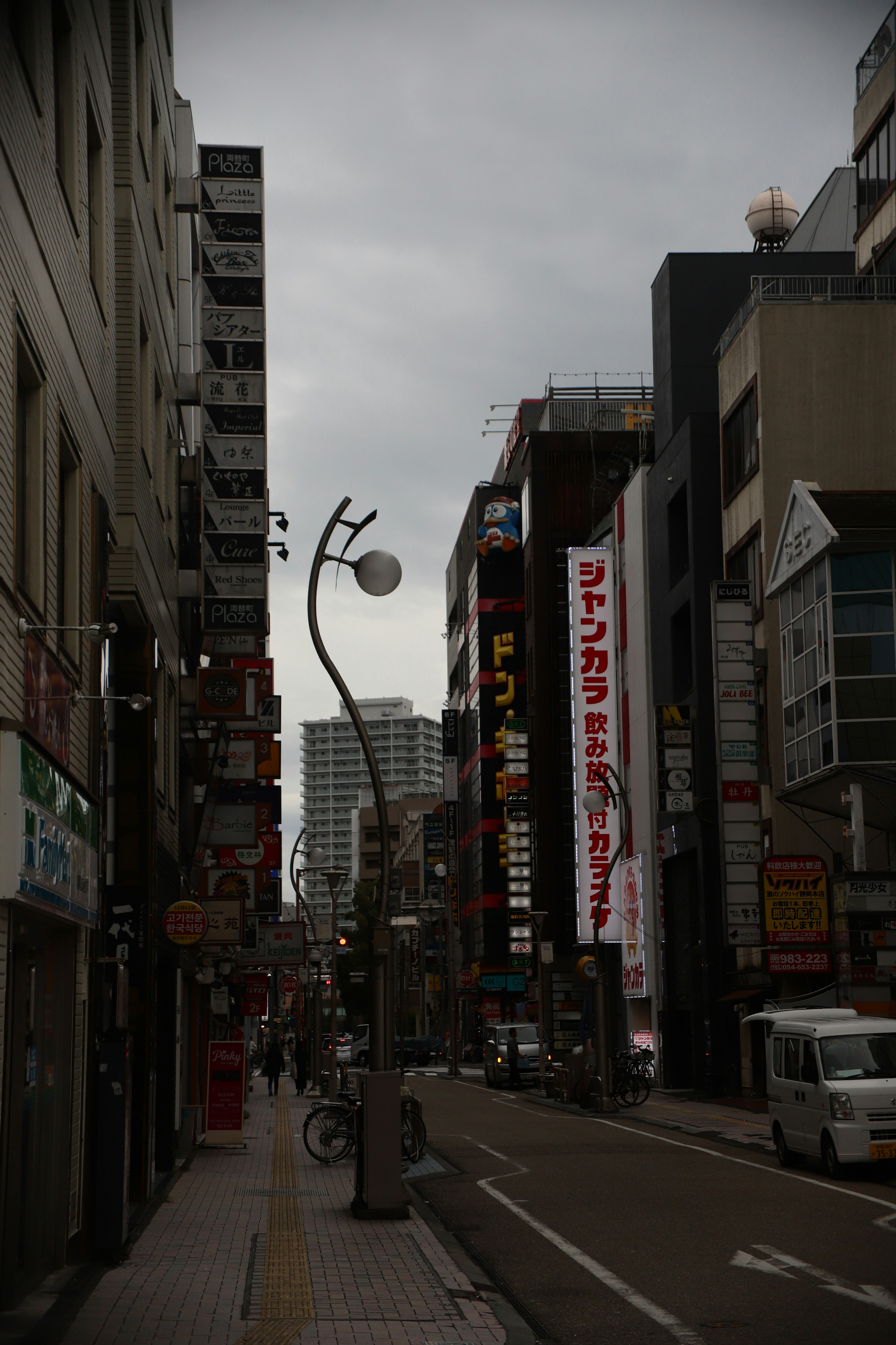 City street view with buildings, street lamp, and signage