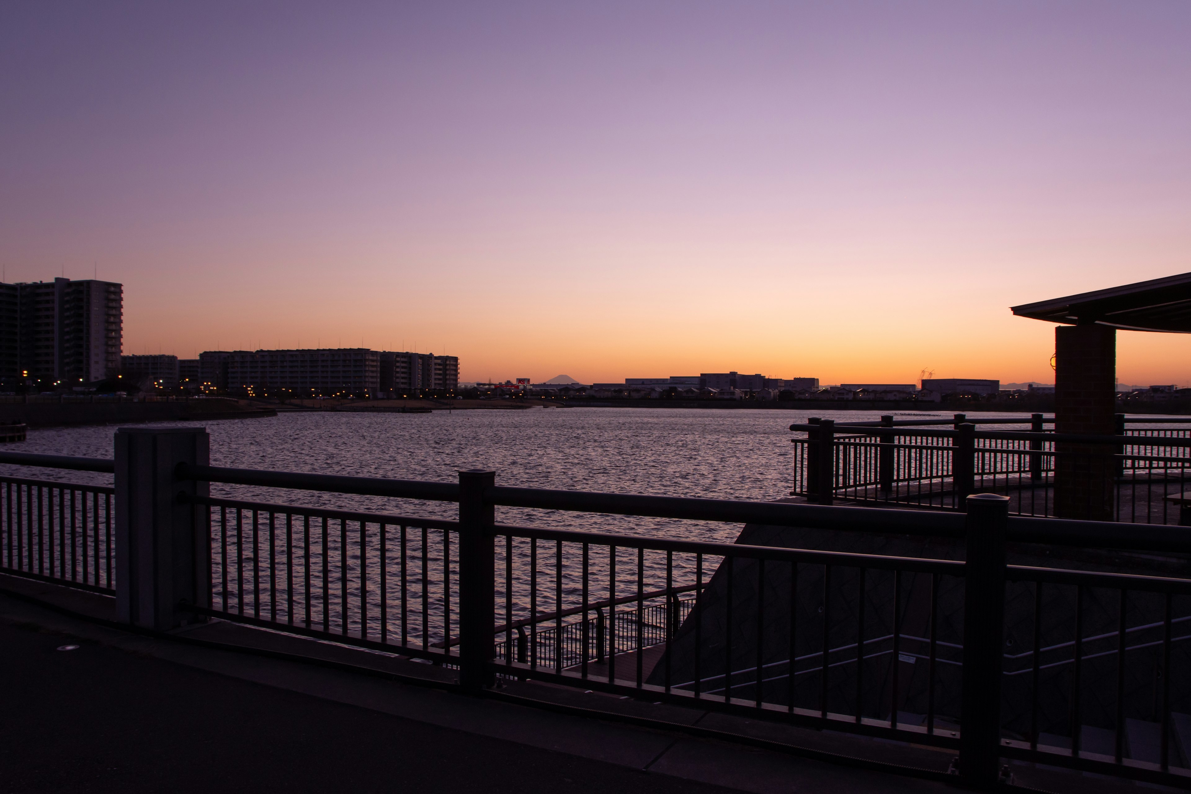 Sunset view of the waterfront with railings