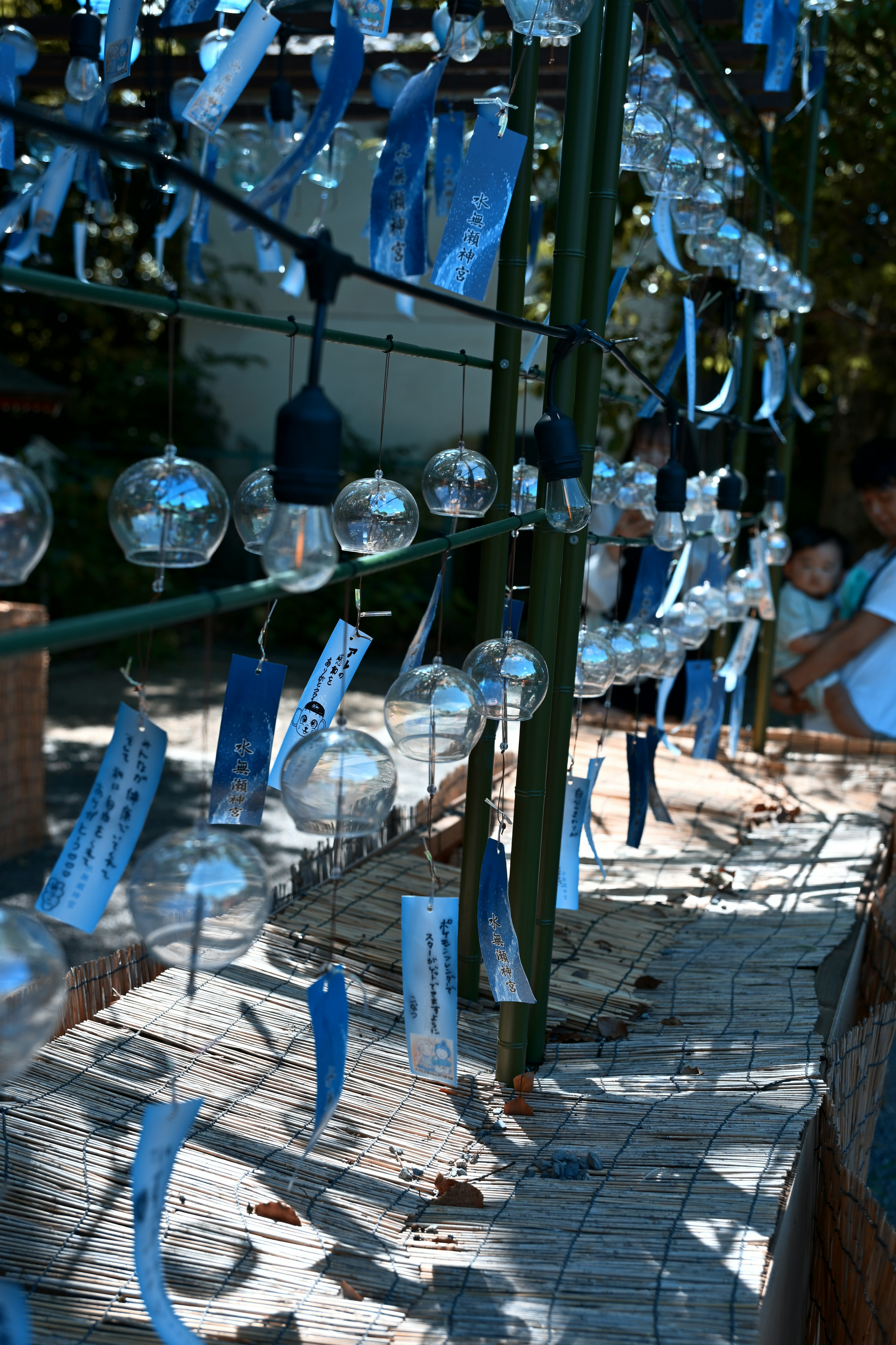 A beautiful scene with wind chimes hanging and blue tags