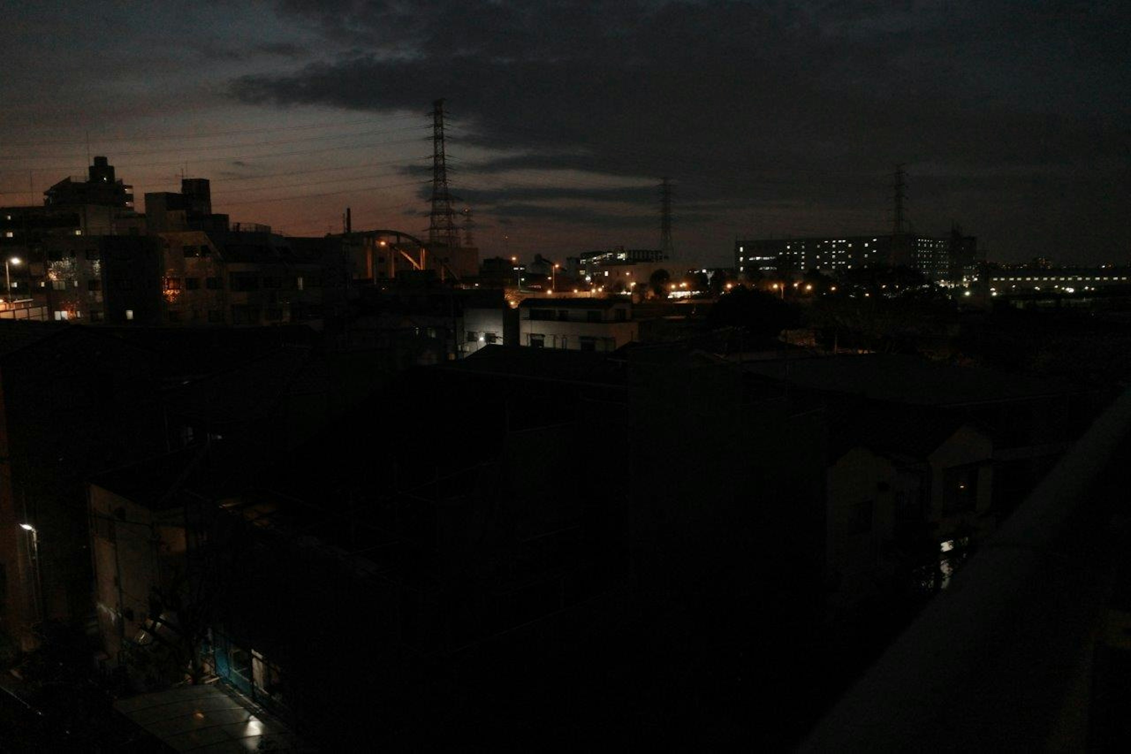 Night cityscape with glowing lights against a dark sky