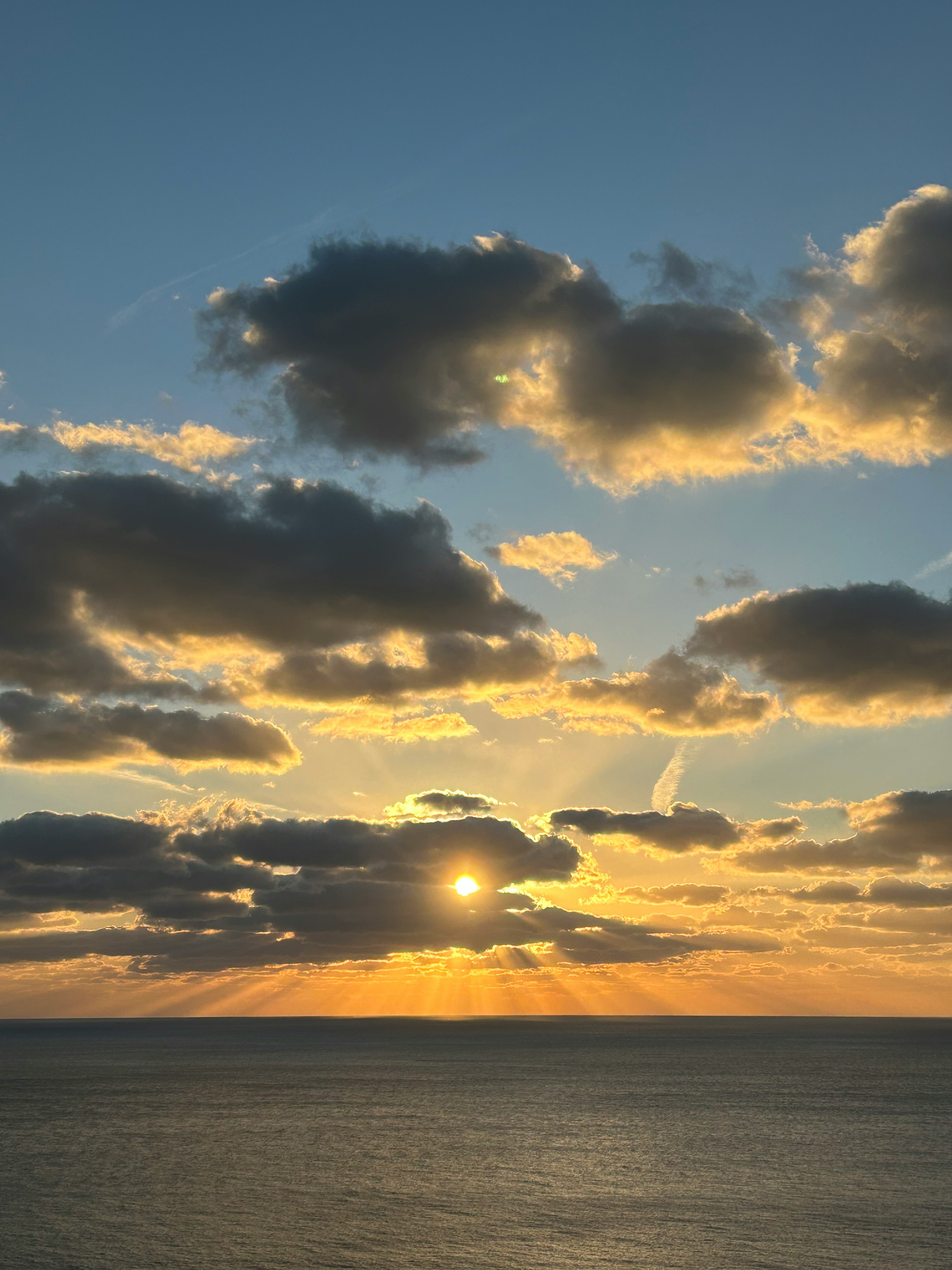 A beautiful sunset over the ocean with dramatic clouds