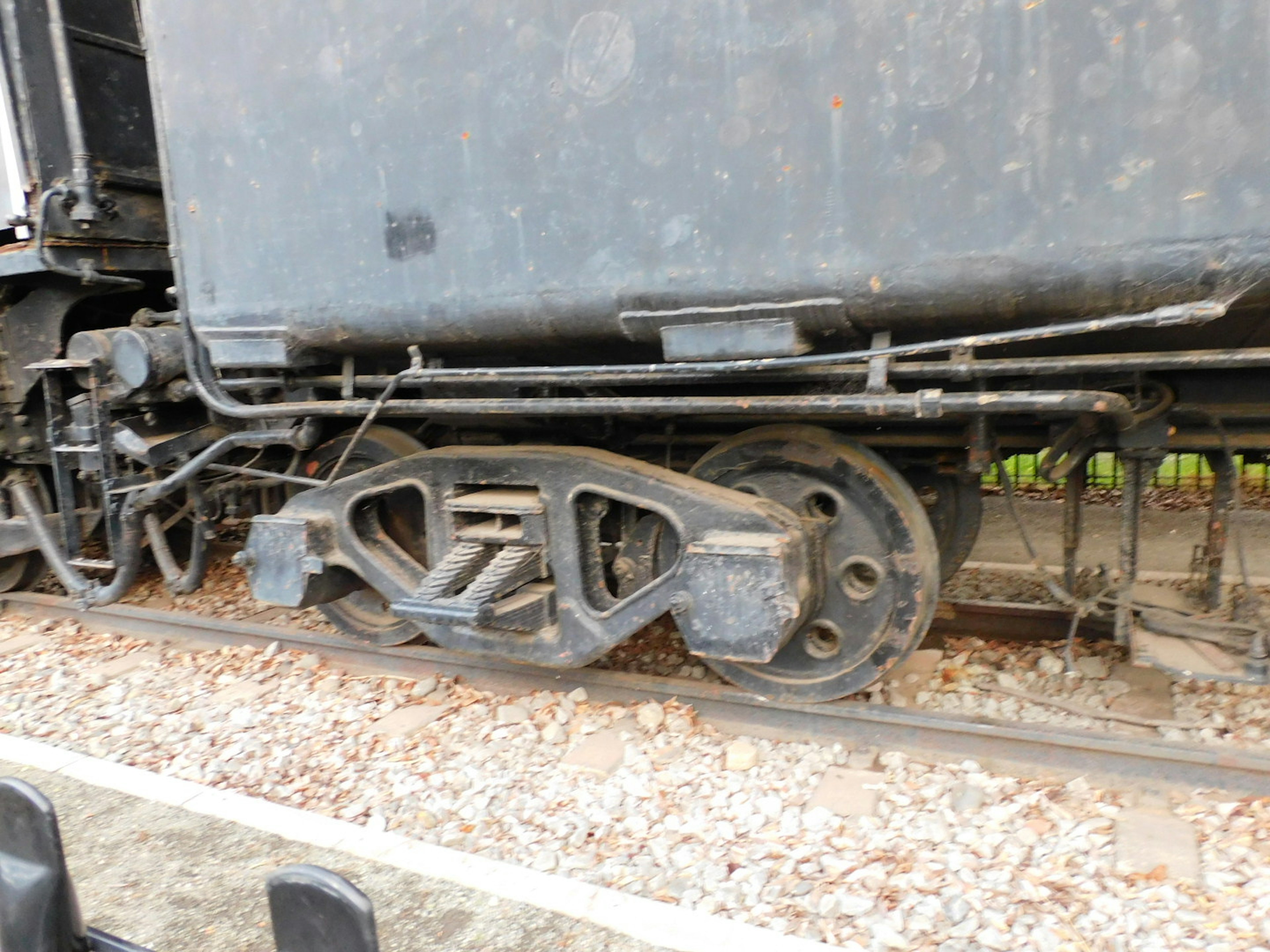 Close-up of a train wheel and mechanical components