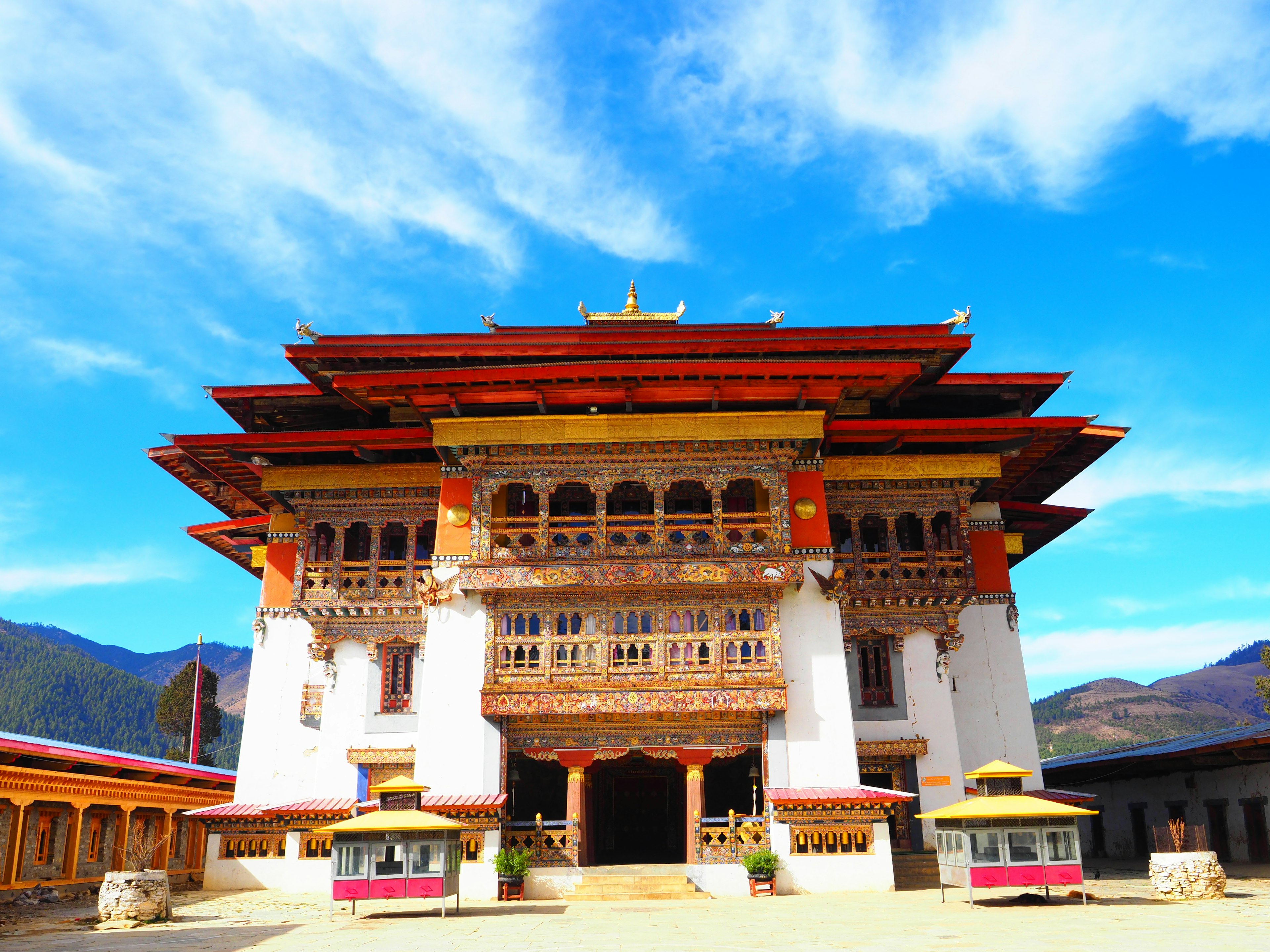 Traditional Bhutanese architecture under a beautiful blue sky