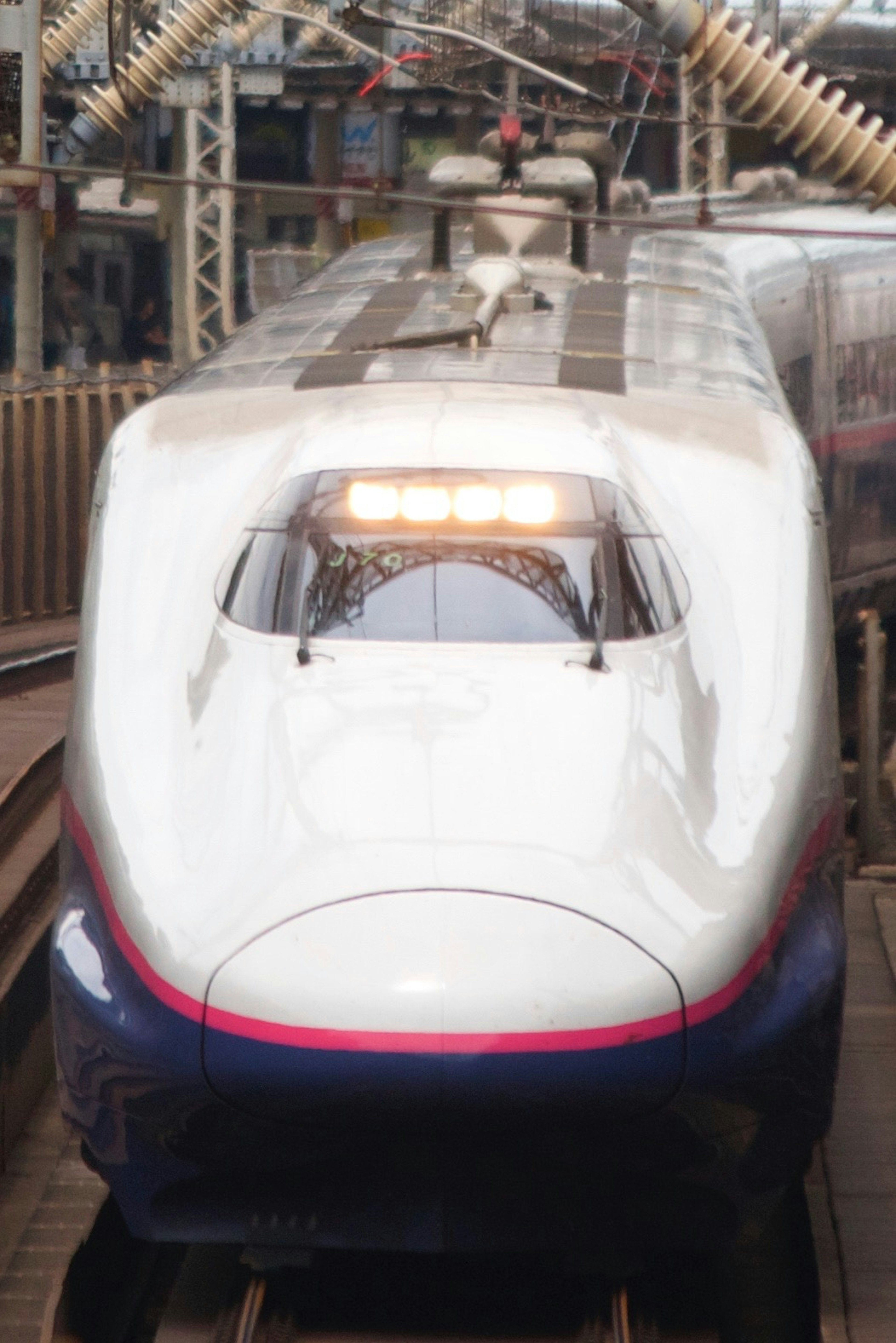 Front view of a Shinkansen train at a station