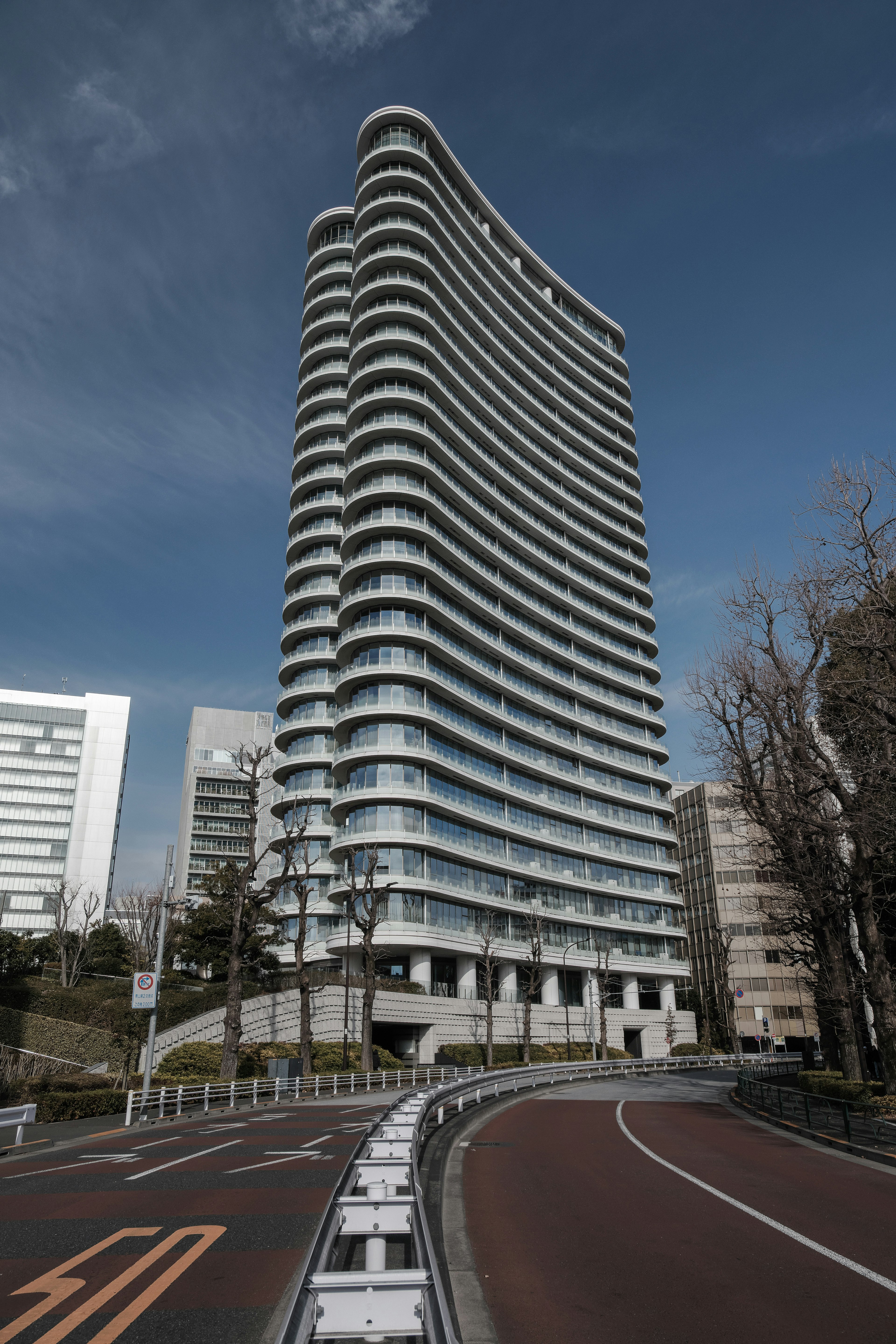 Curved high-rise building under a blue sky