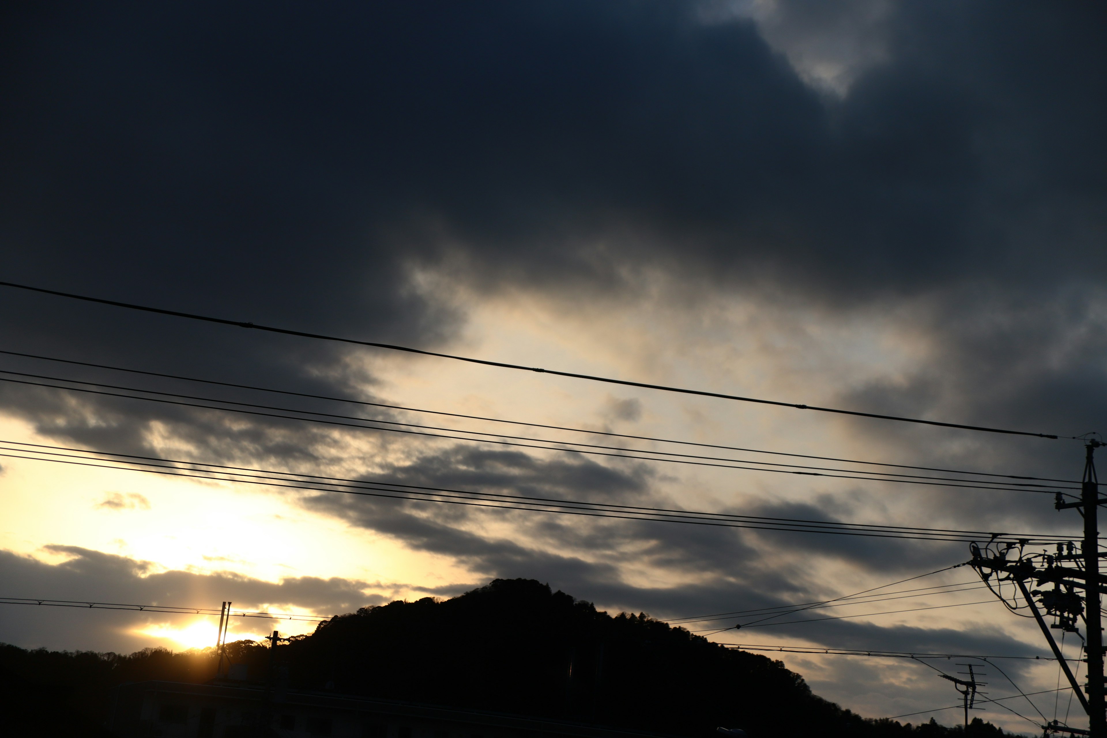 Sunset view with mountains and cloudy sky