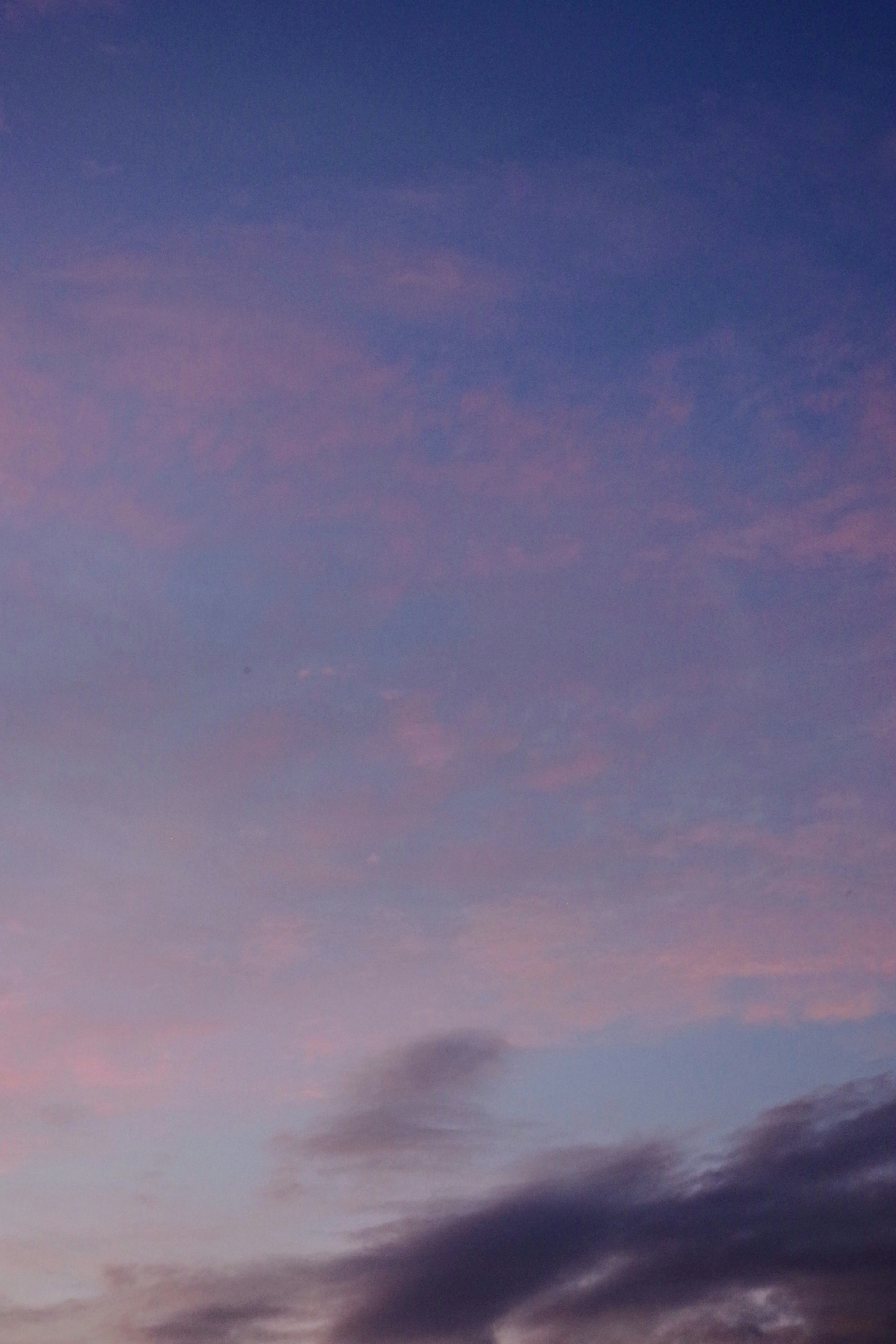 Un paesaggio con un cielo viola chiaro e nuvole