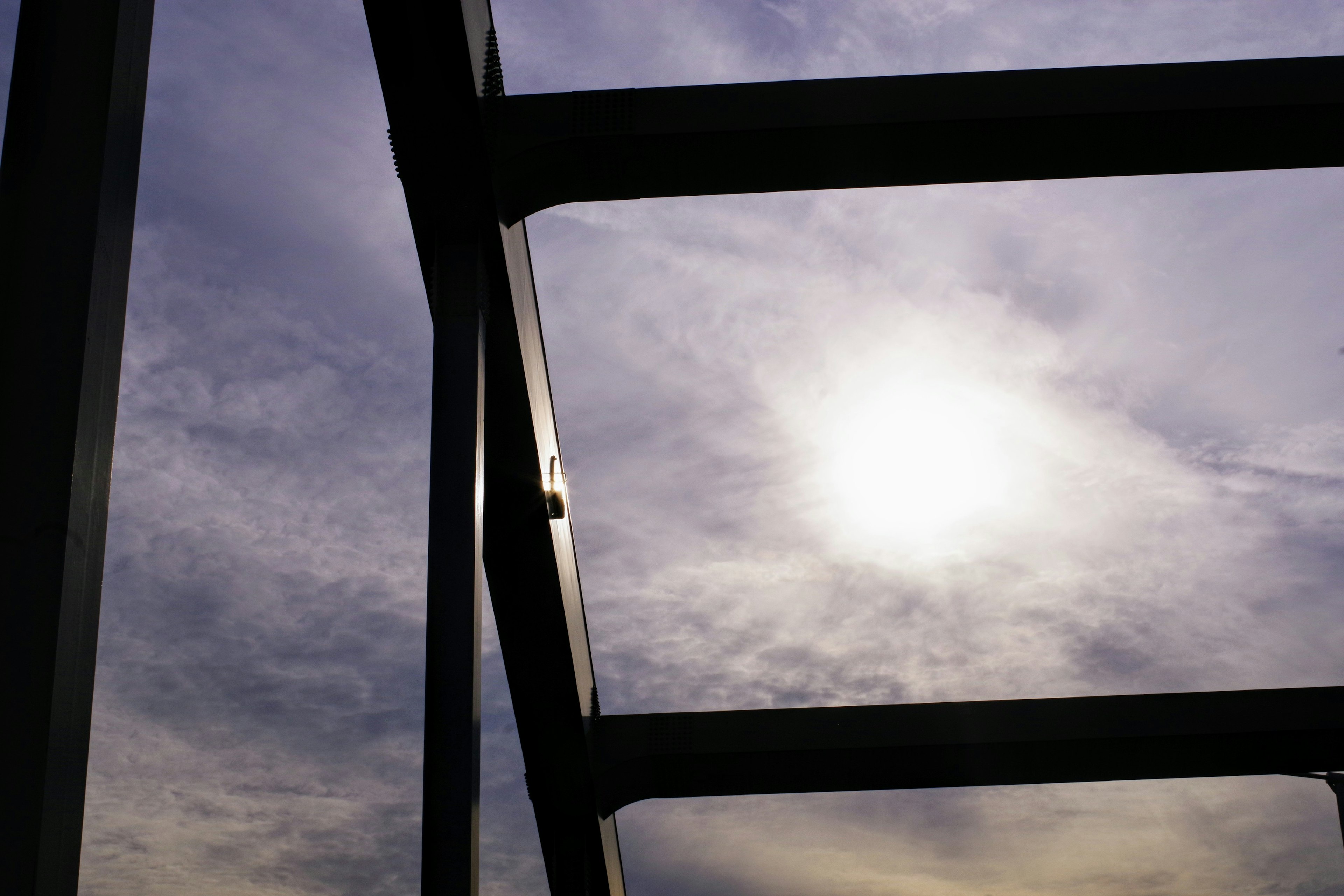 Steel structure frame with cloudy sky and sunlight