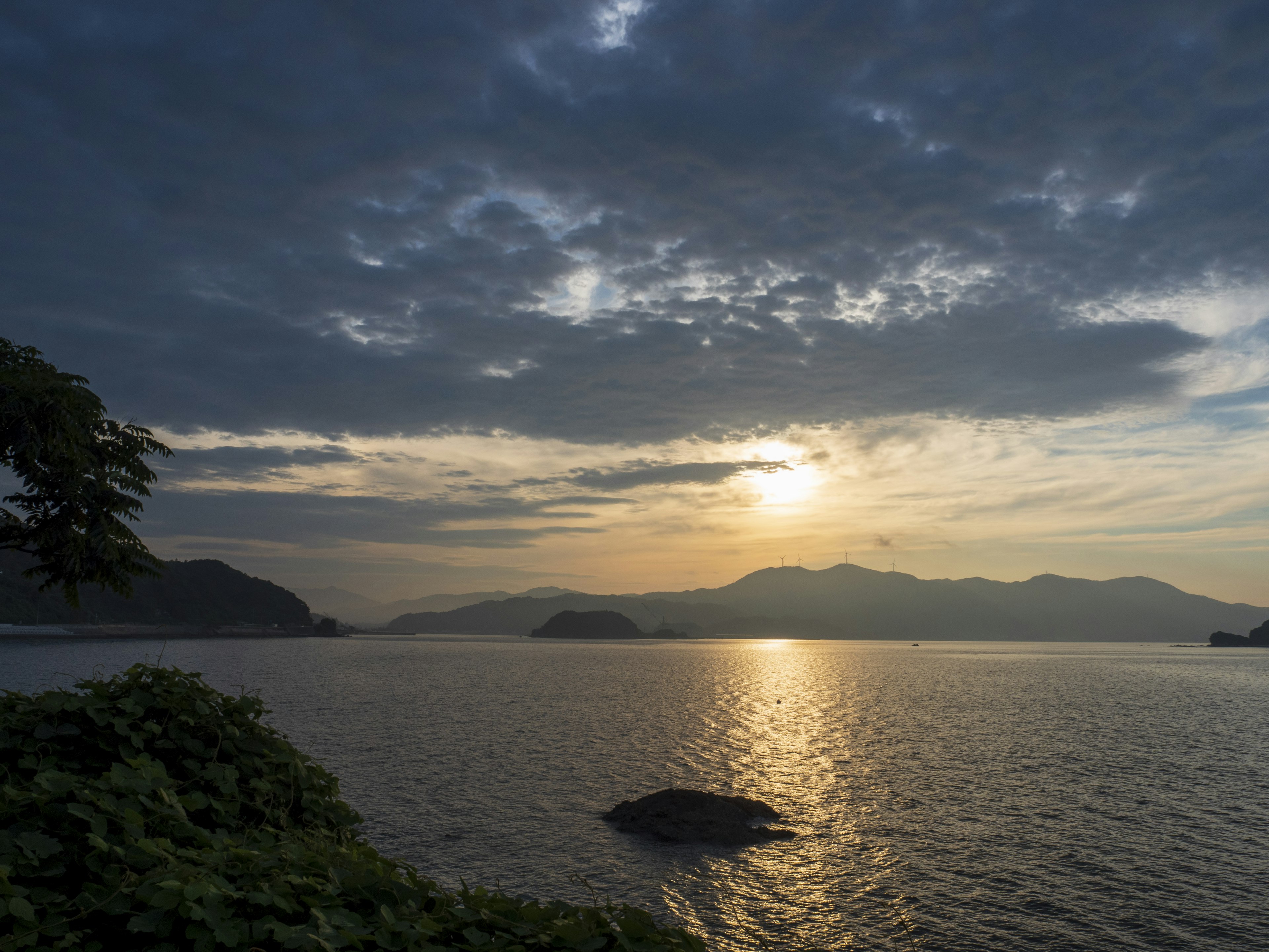 Coucher de soleil tranquille sur un lac illuminant les montagnes environnantes