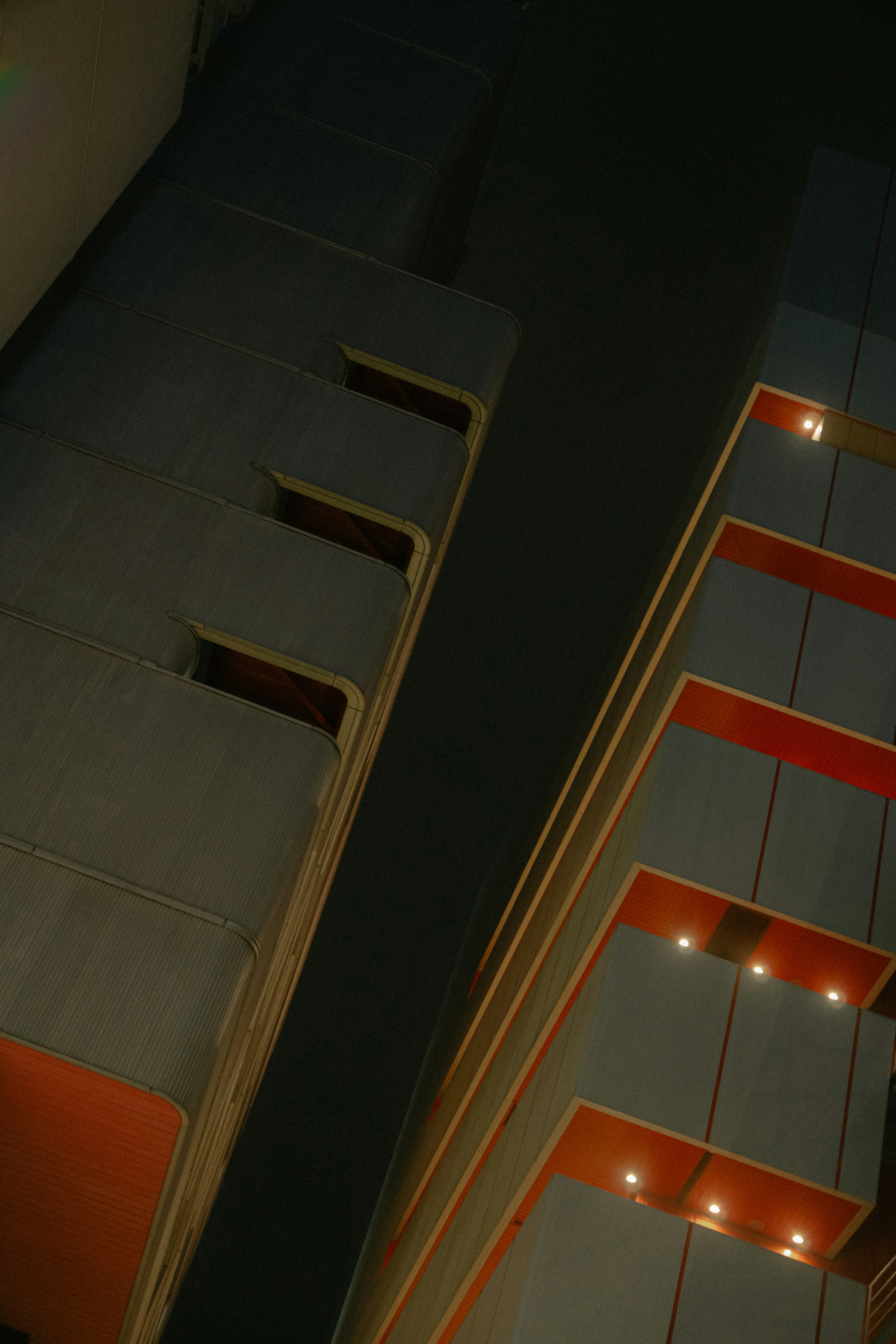 Modern building exterior viewed from above at night with distinct lighting