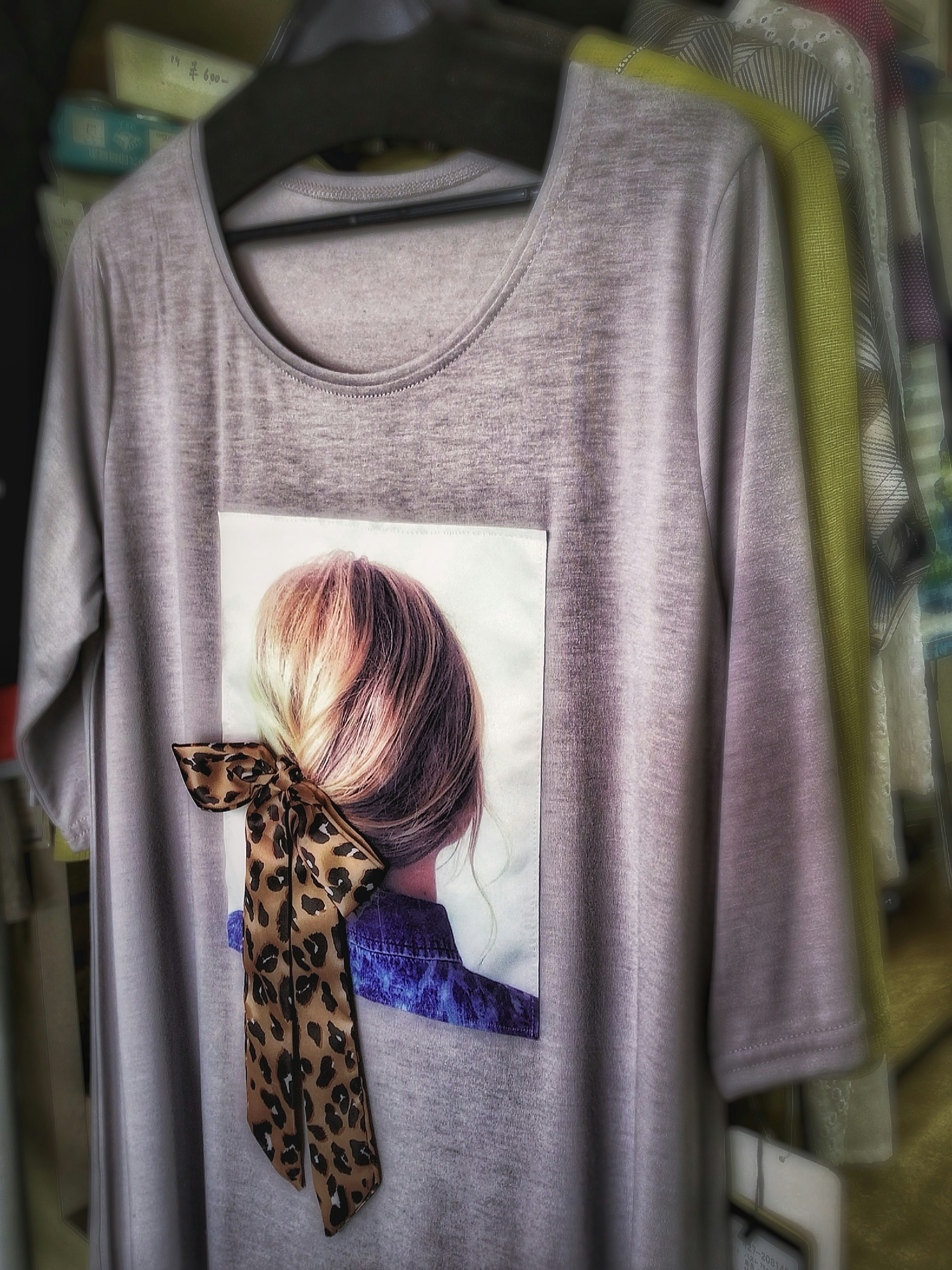 Unique gray T-shirt featuring a photo of a woman's back and a leopard print bow