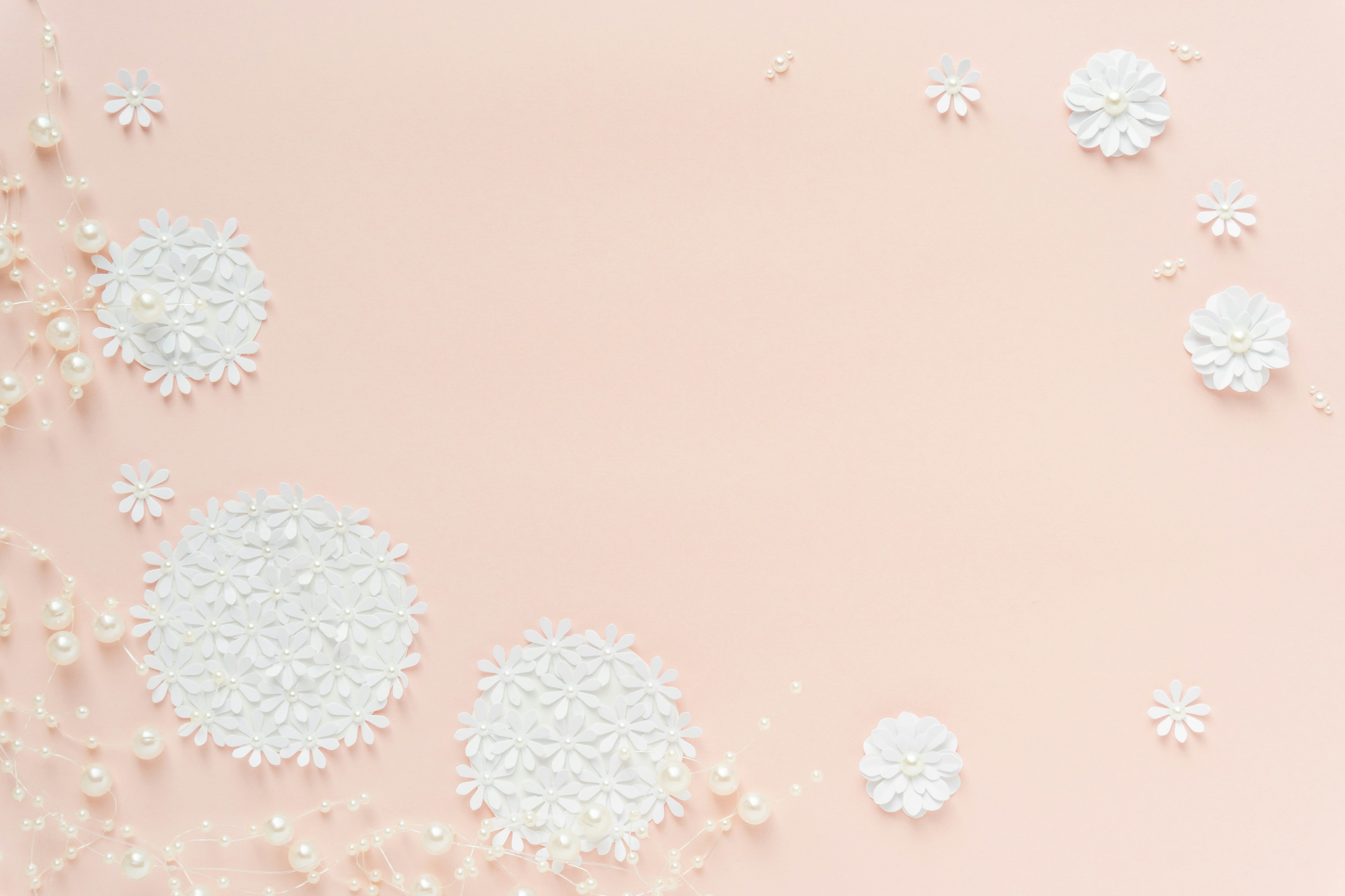 Light pink background with white powder and flower-like shapes scattered across