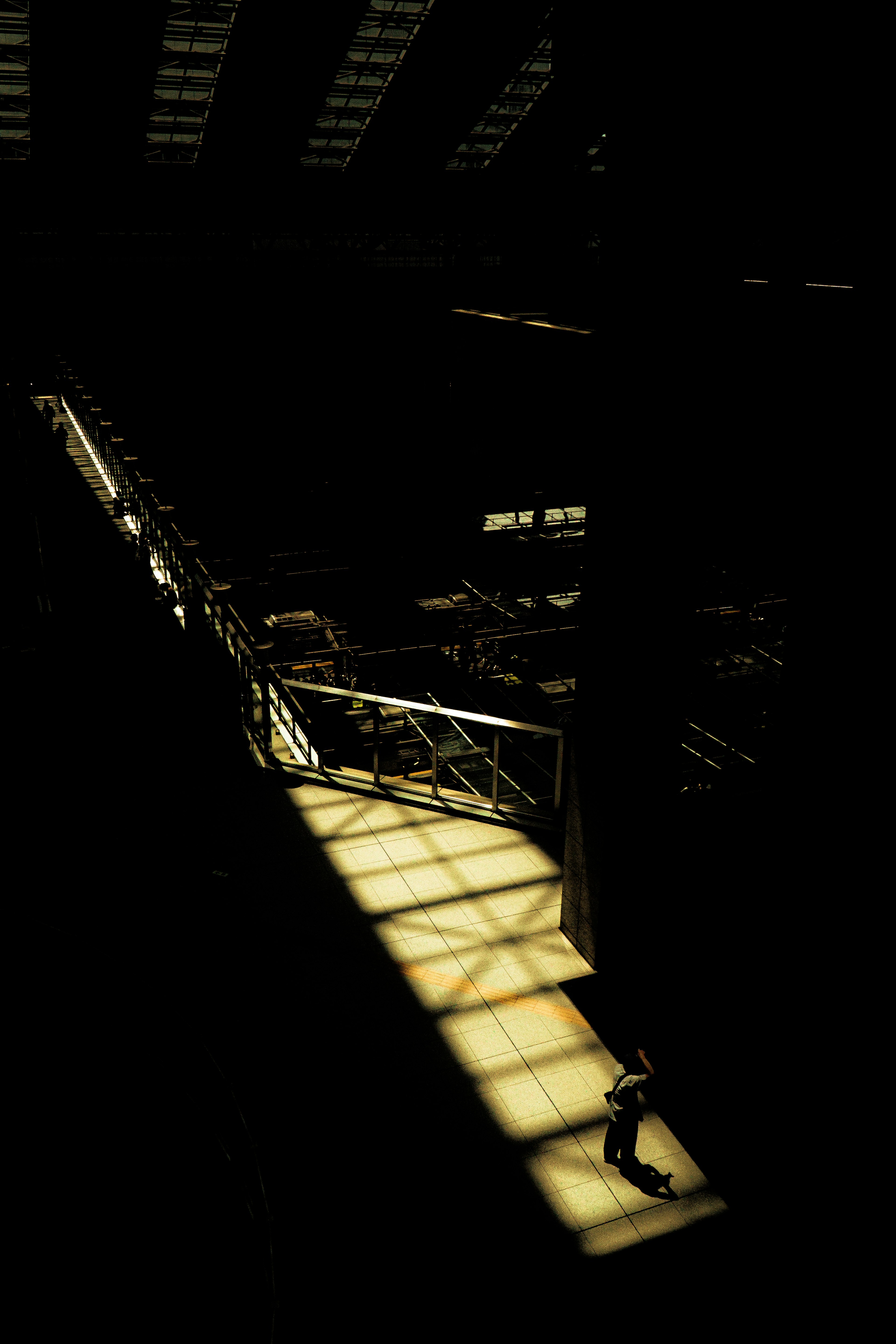 Interior of a factory with light streaming through in a dark space