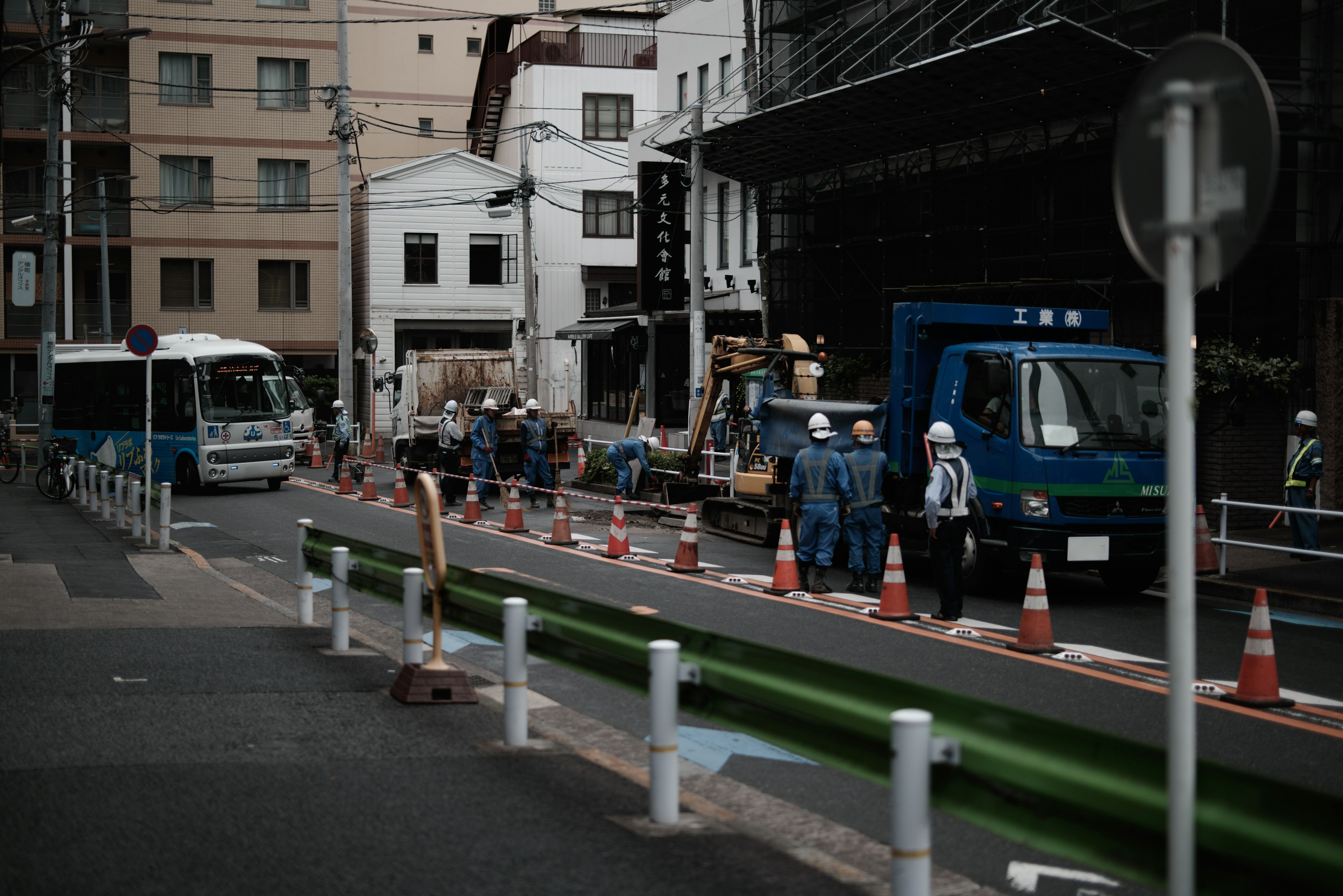 Urban scene with workers and trucks at a construction site