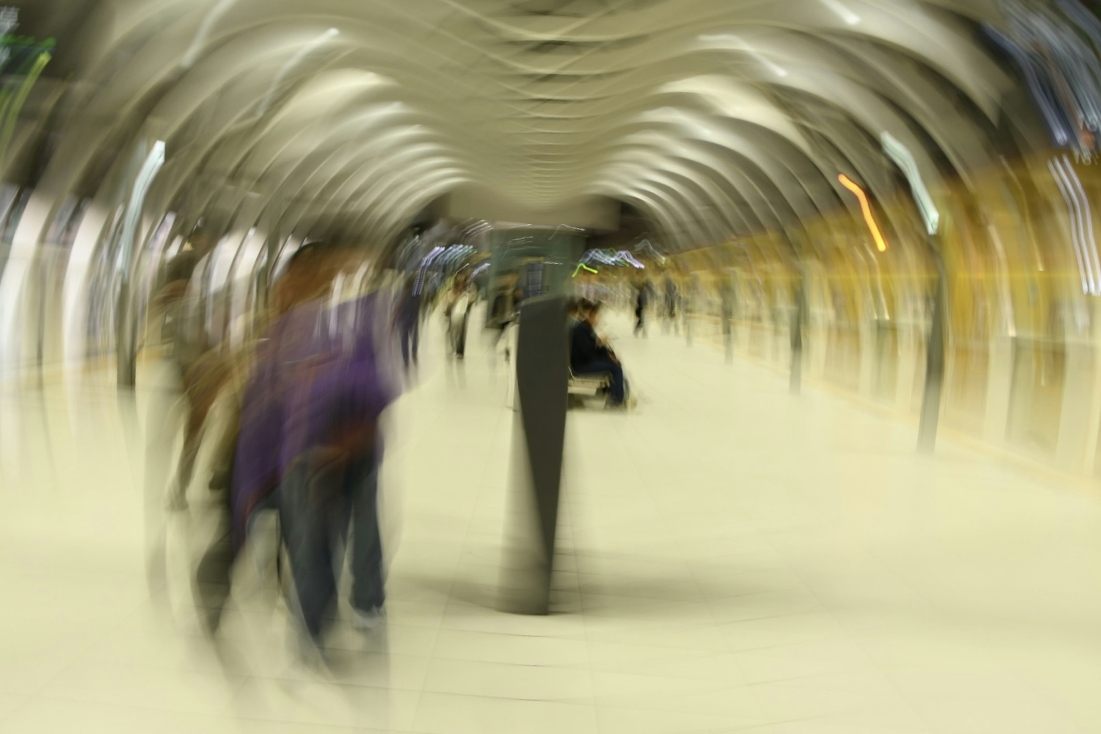 Blurred figures walking on a train platform