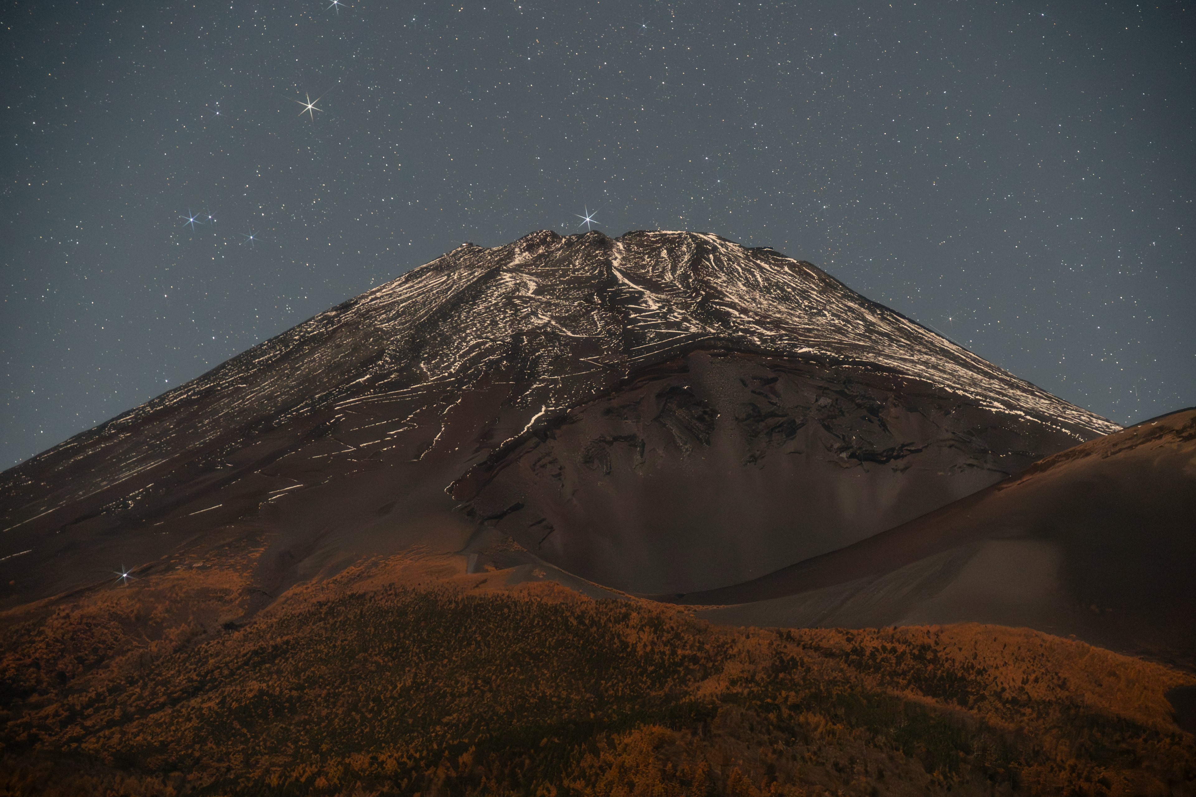 雪をかぶった山と星空の夜景