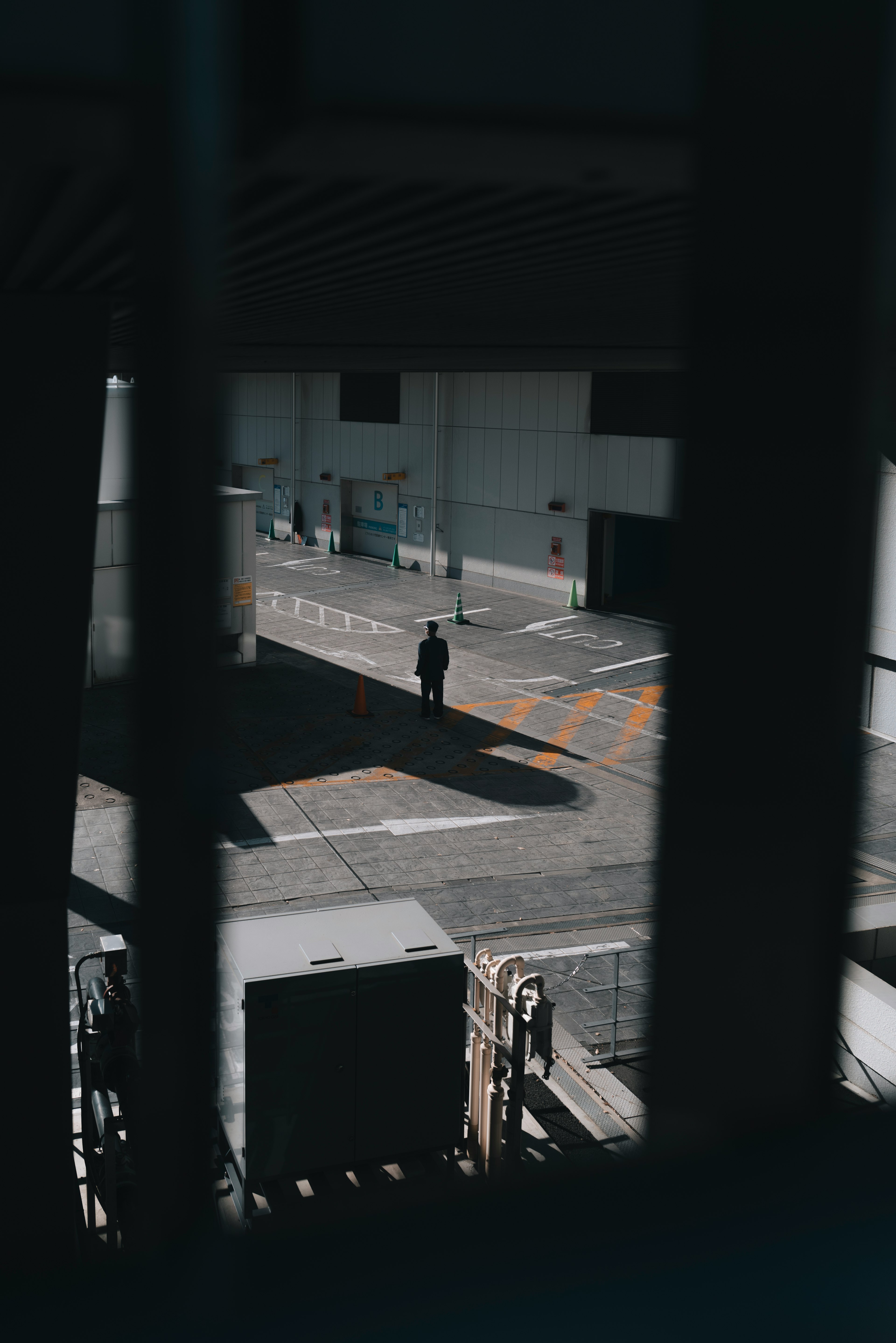 一名站在阴影中的人物与周围城市空间