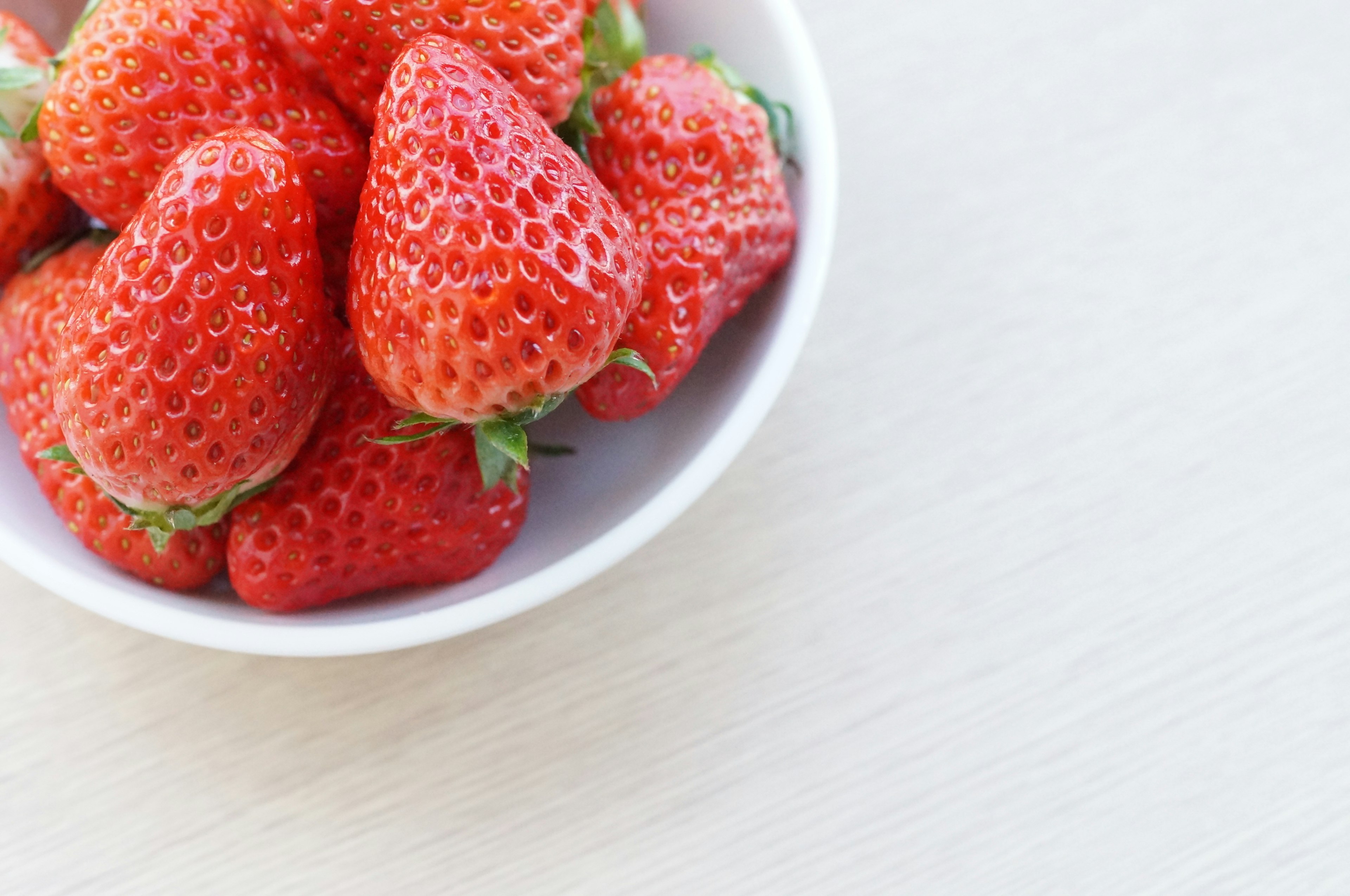 Close-up of fresh strawberries in a white bowl