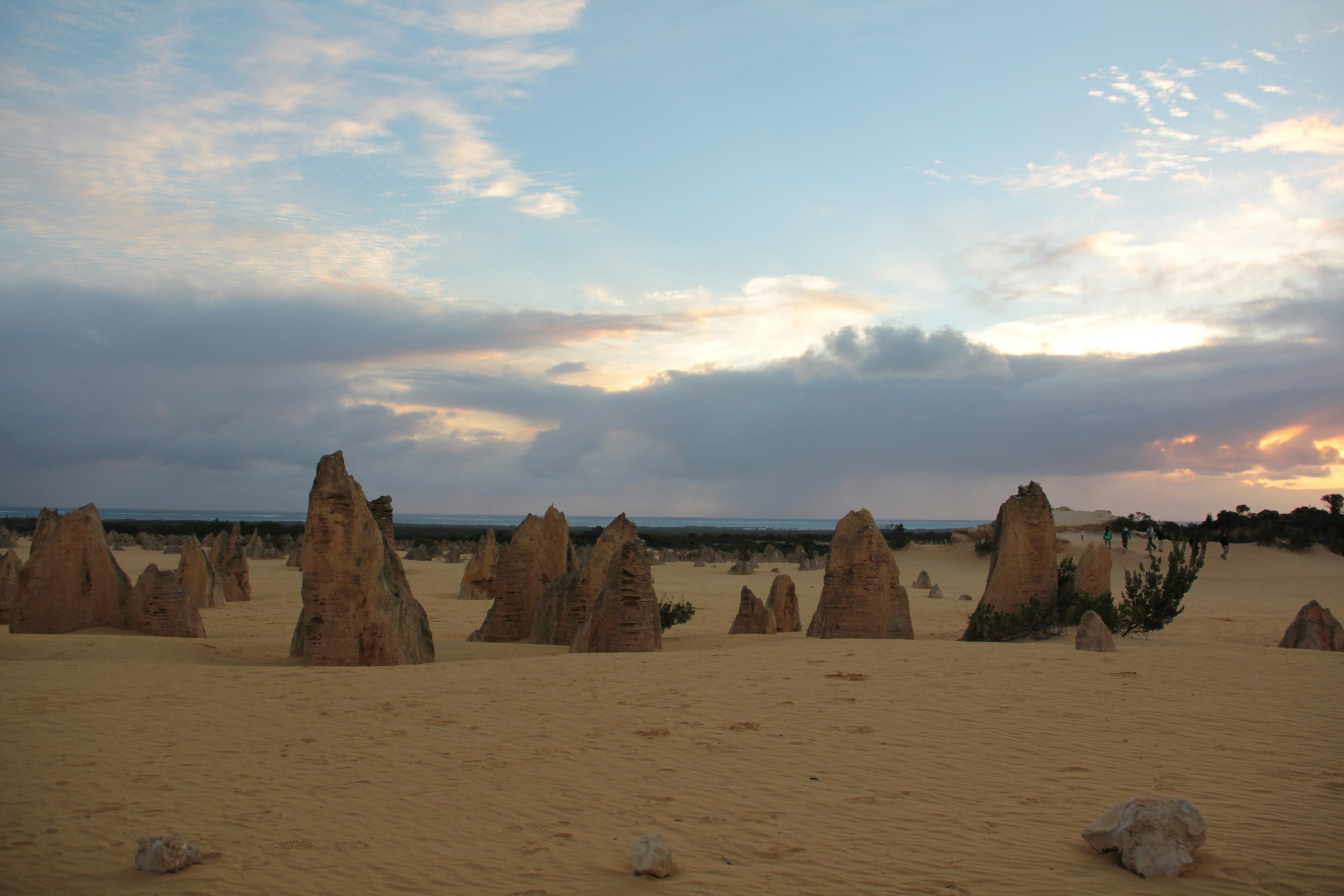 Landscape of unique rock formations under a colorful sunset