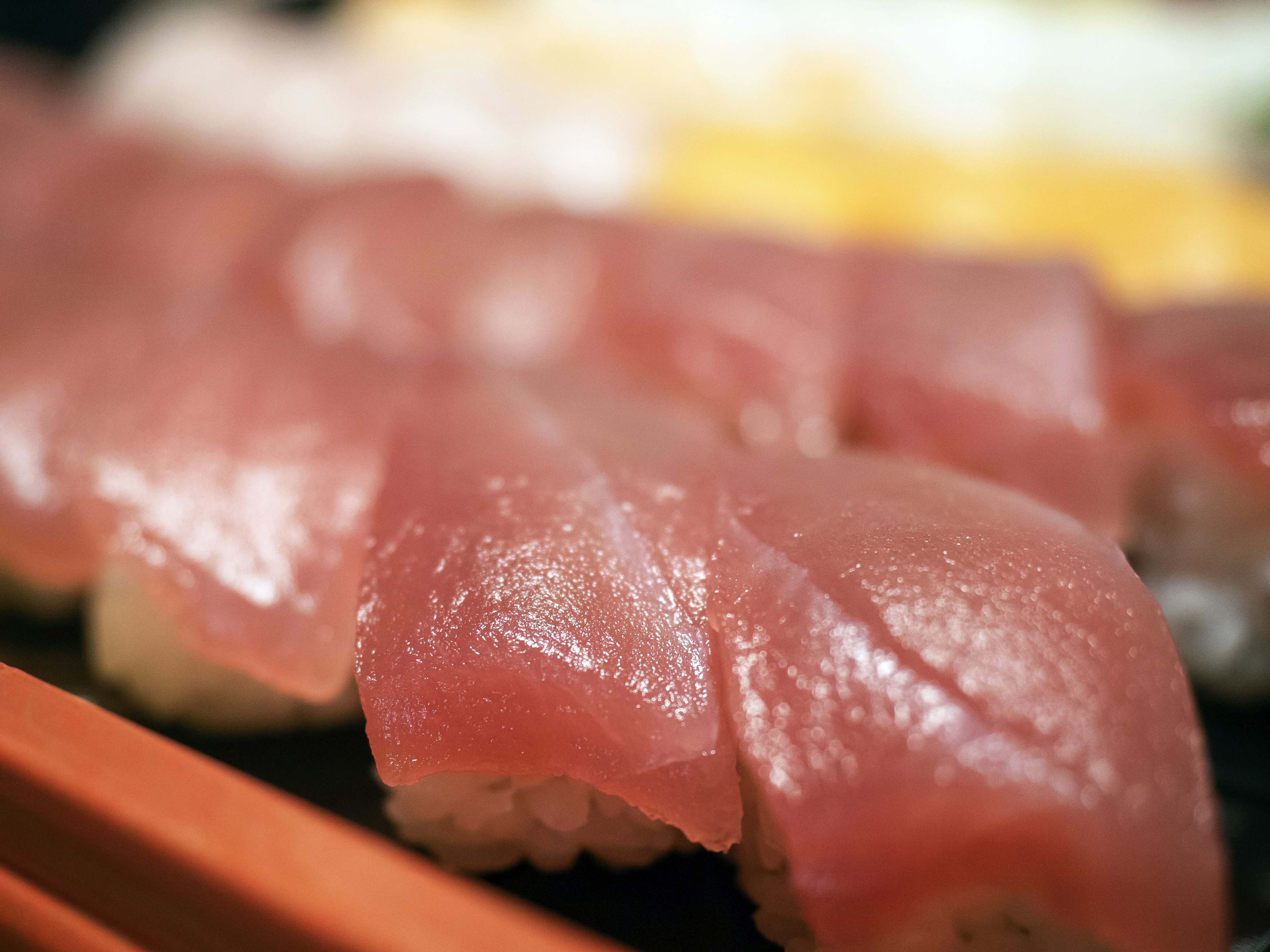 A beautiful plate of fresh tuna sushi arranged neatly