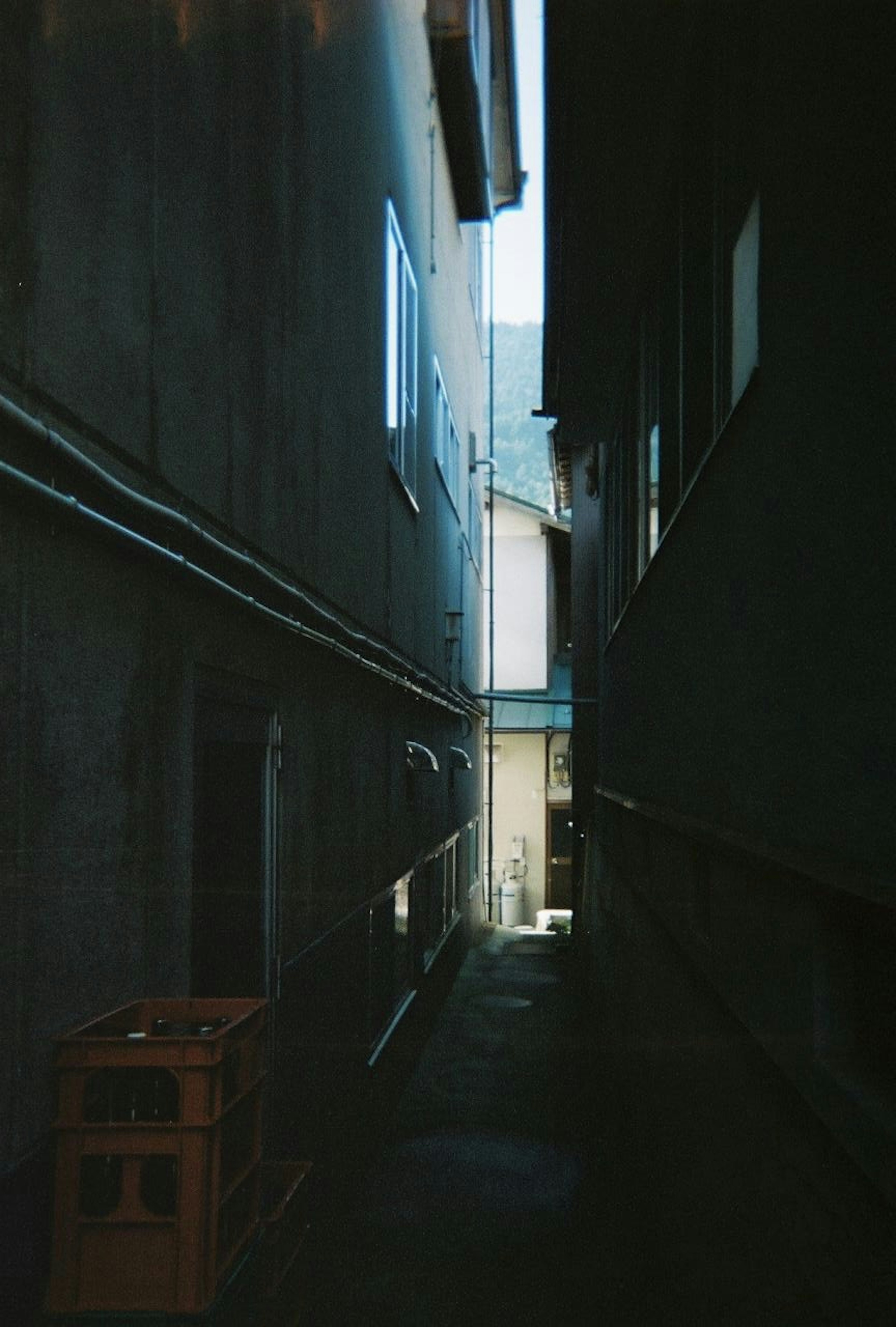 Narrow alley between buildings with walls and light