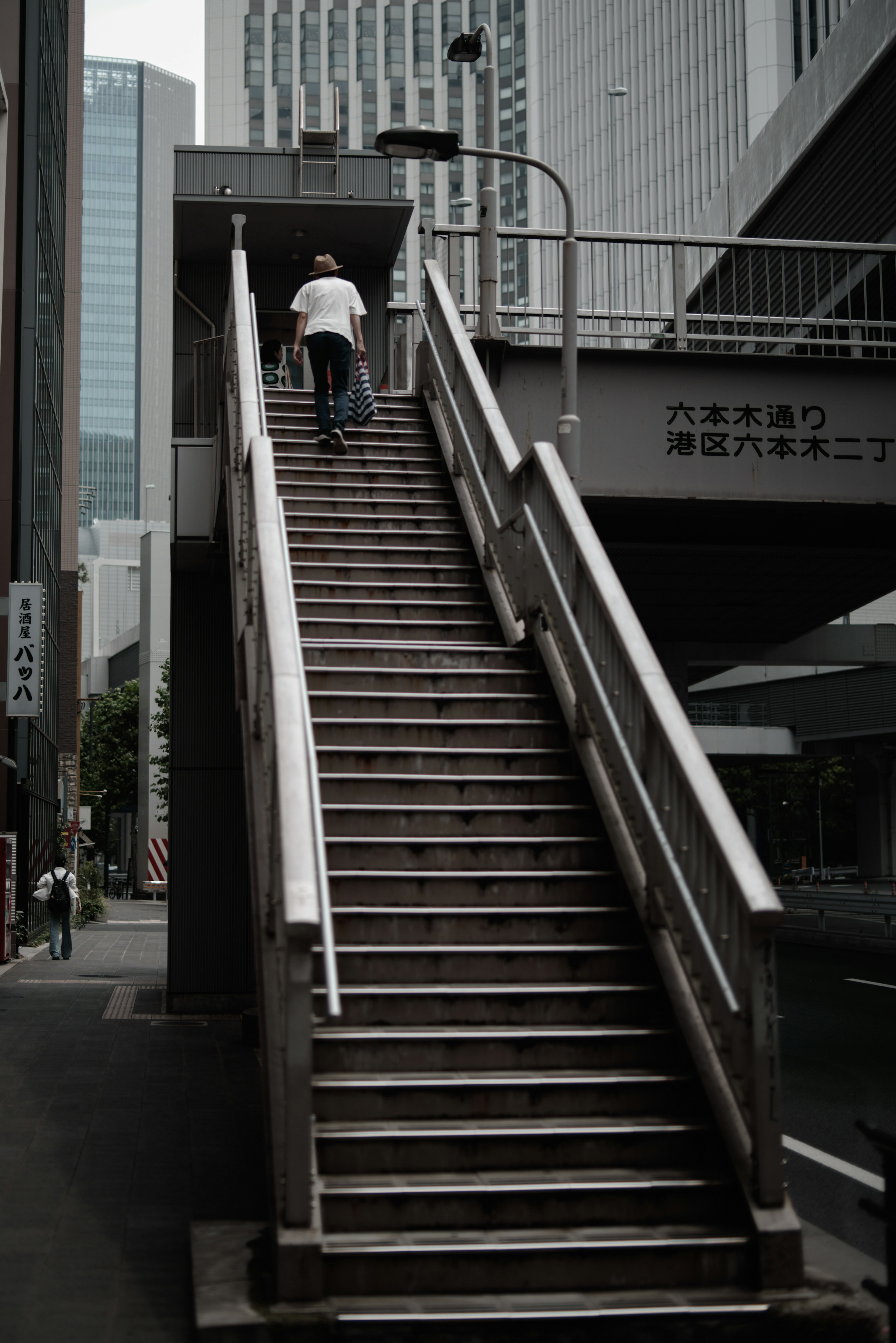 A person climbing a staircase in an urban setting