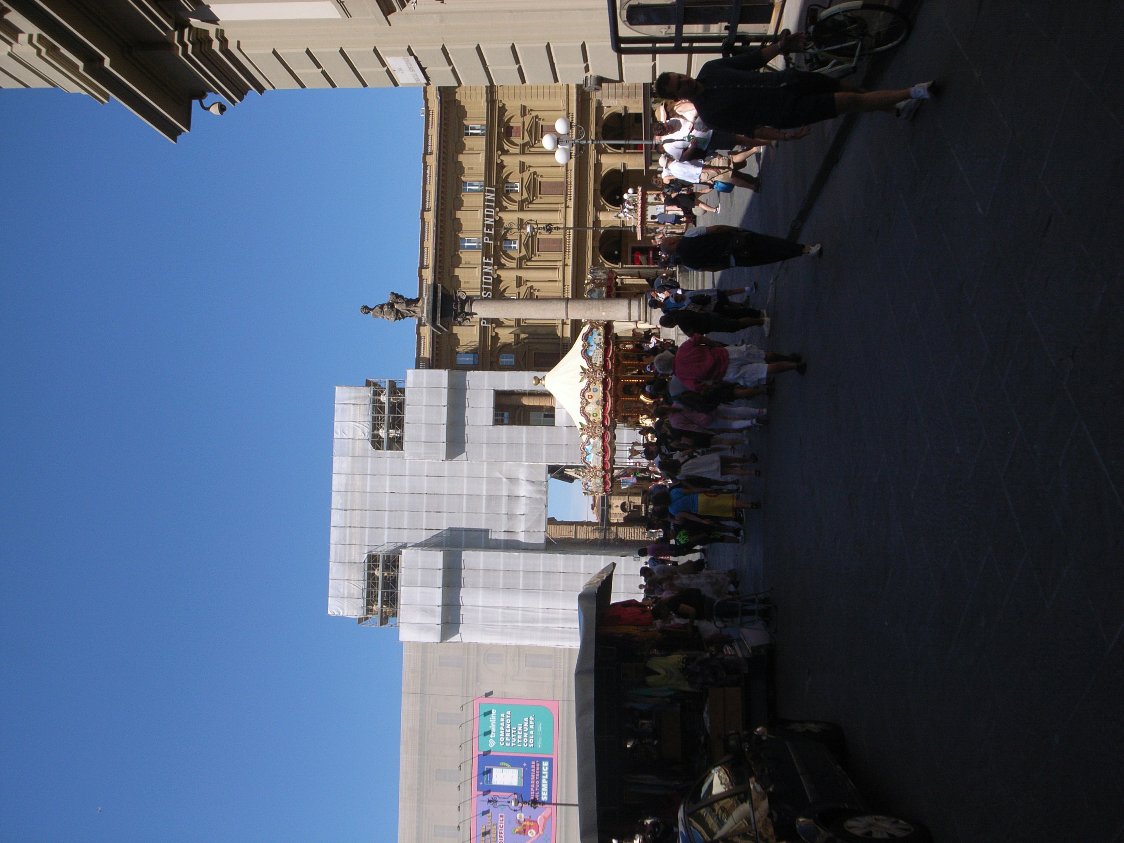 Modern building under a blue sky with a crowd of people