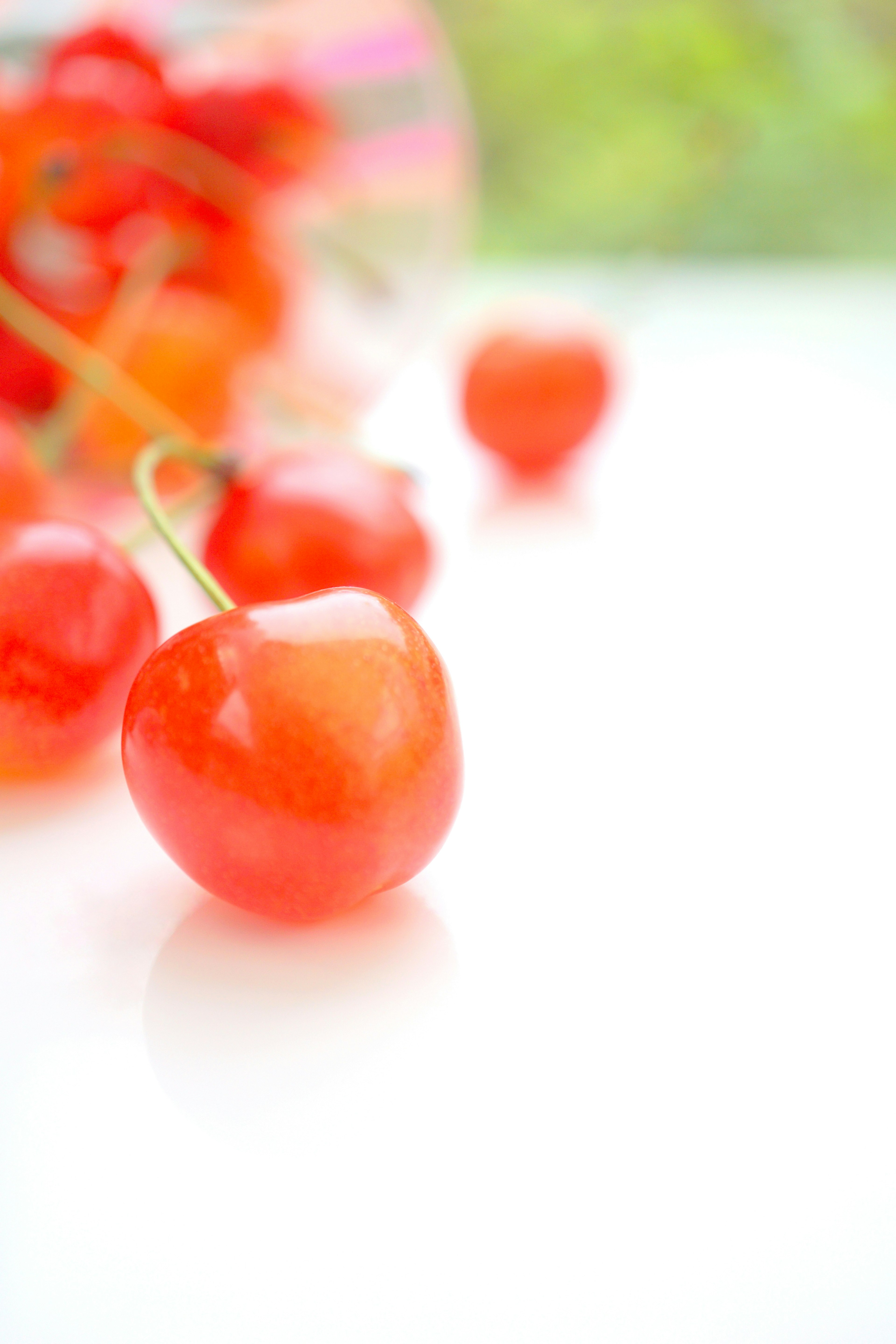 Ciliegie rosse brillanti disposte su uno sfondo bianco