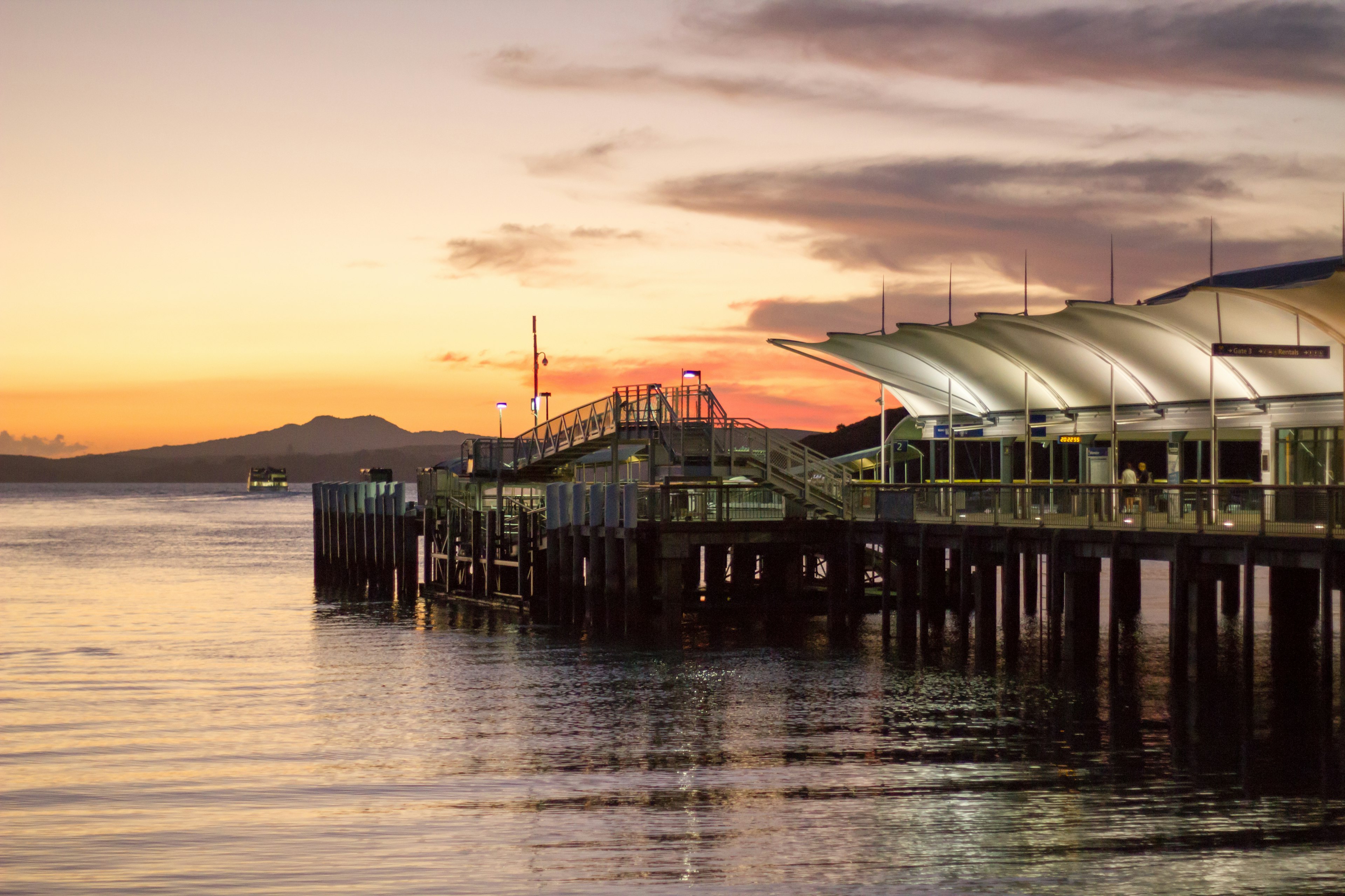 Pier at sunset with calm water reflections