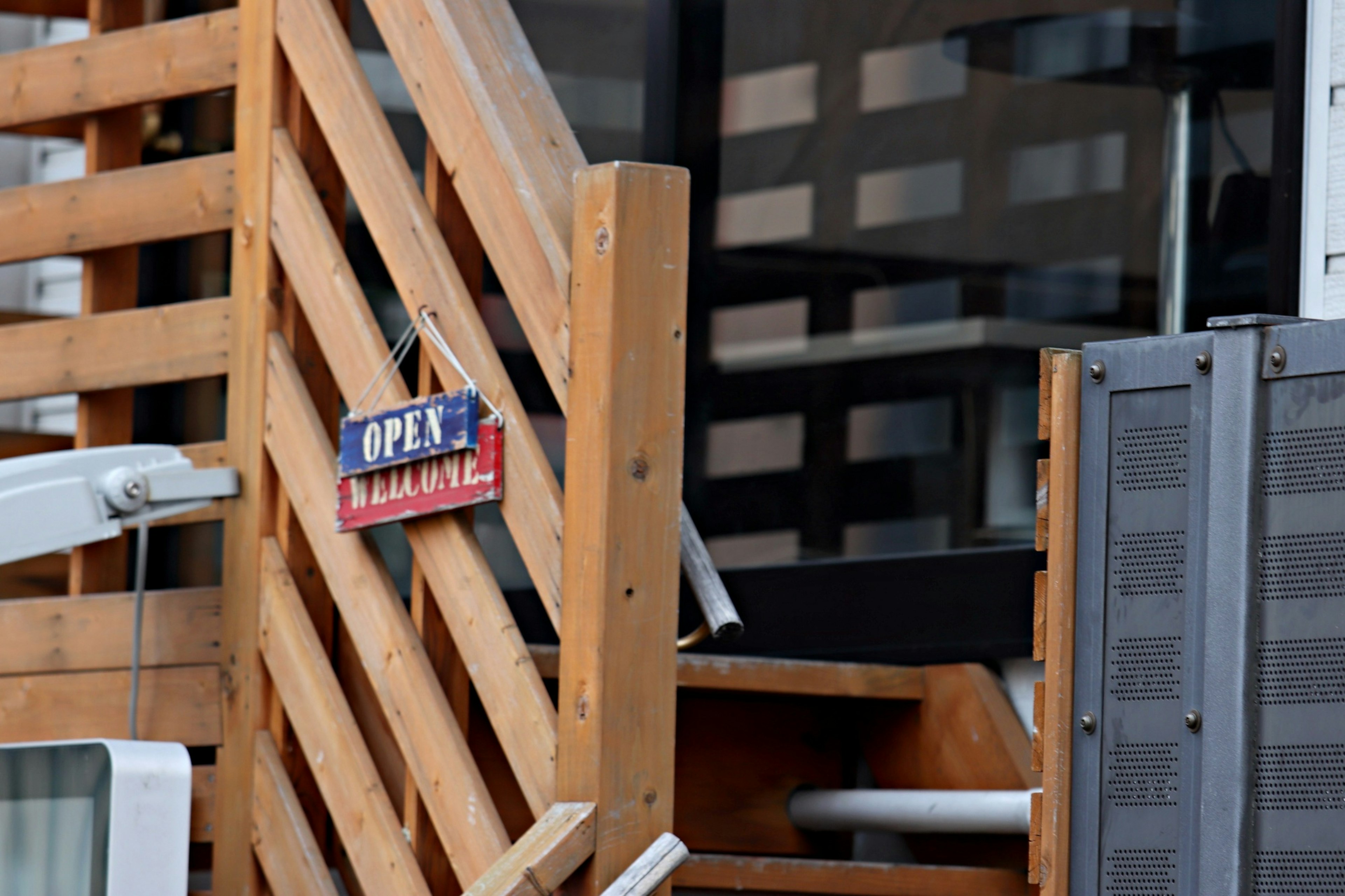 Wooden staircase with an open sign hanging