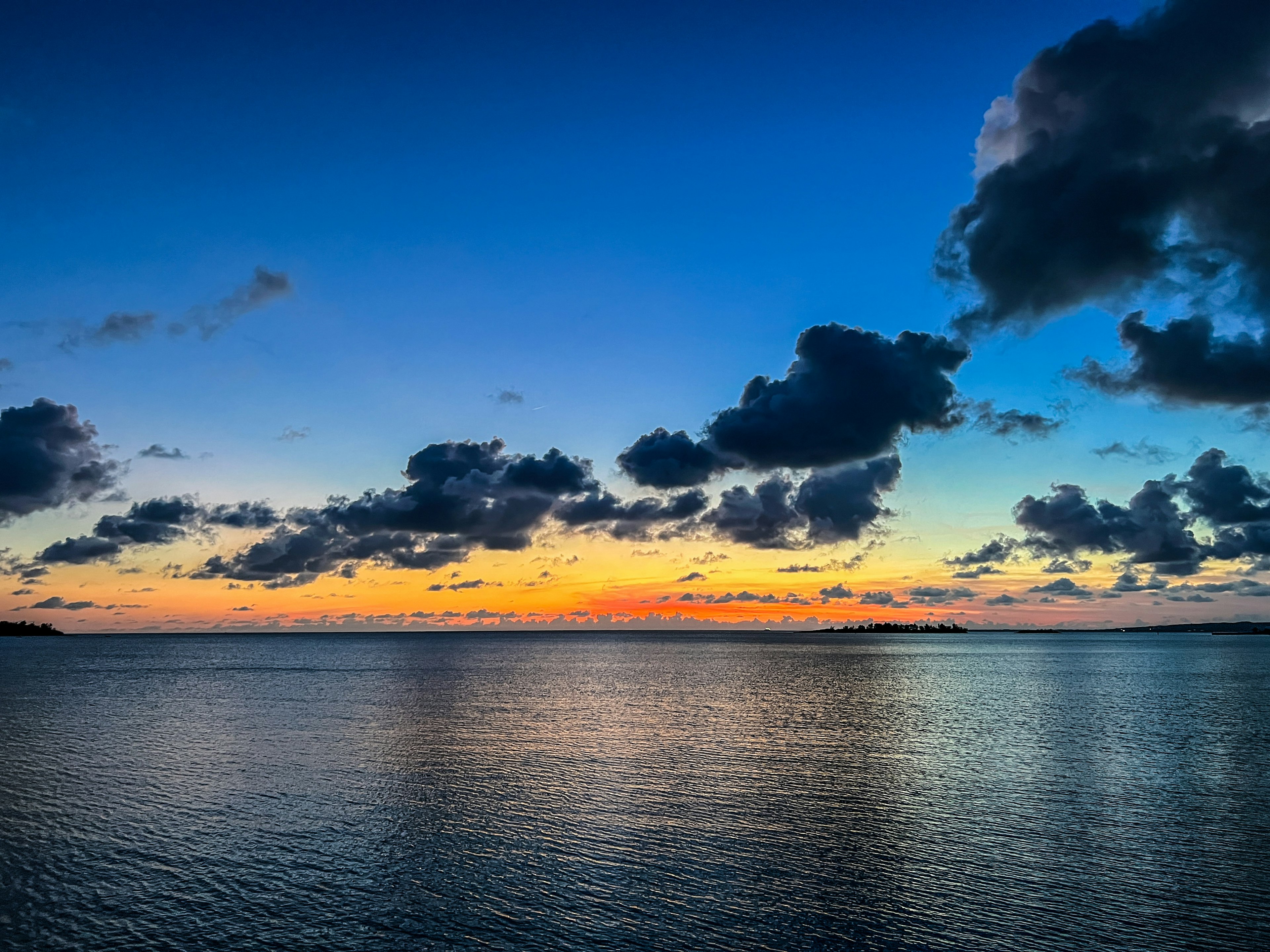 Hermoso paisaje marino al atardecer con un cielo vibrante y nubes