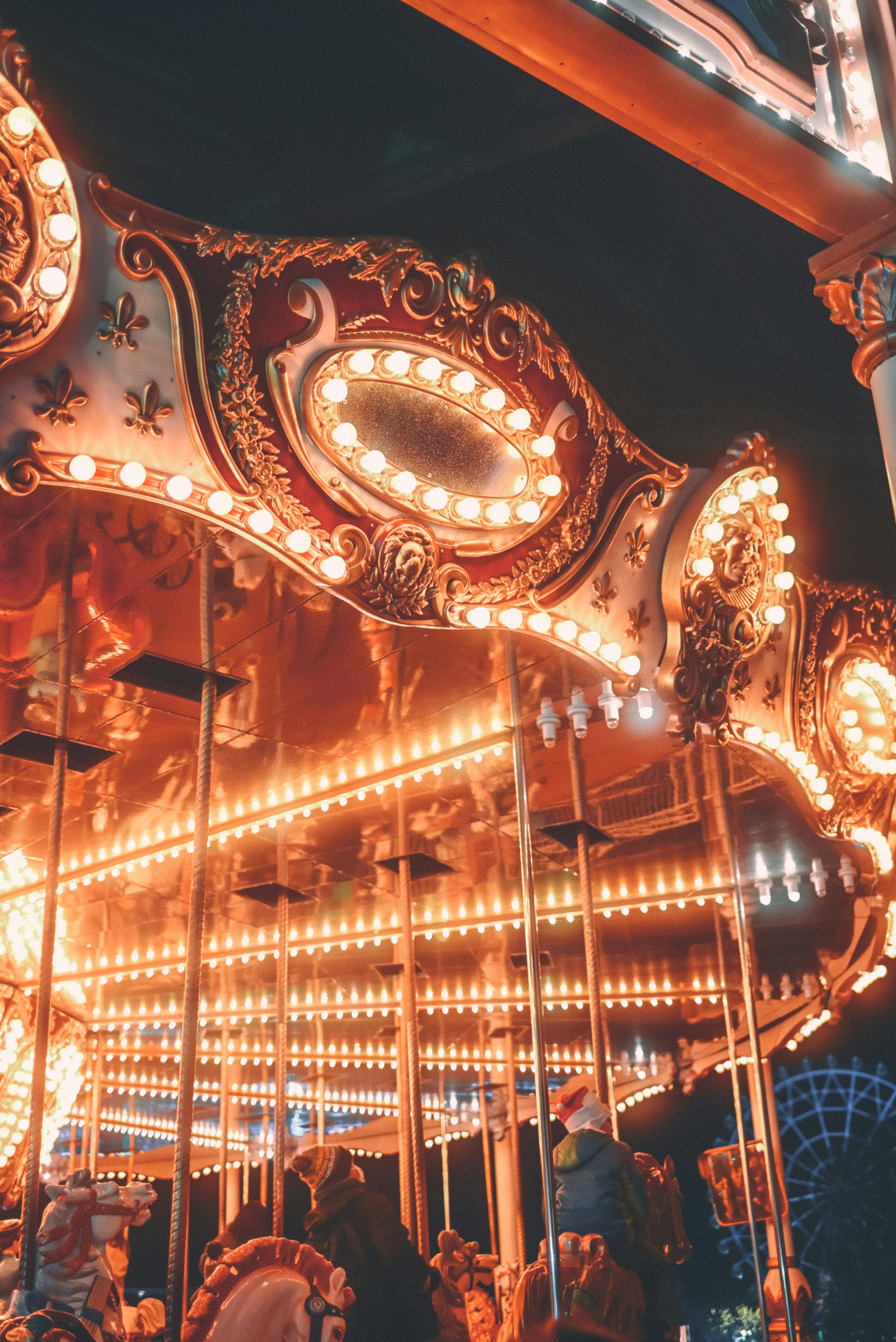 Illuminated carousel with ornate decorations at night