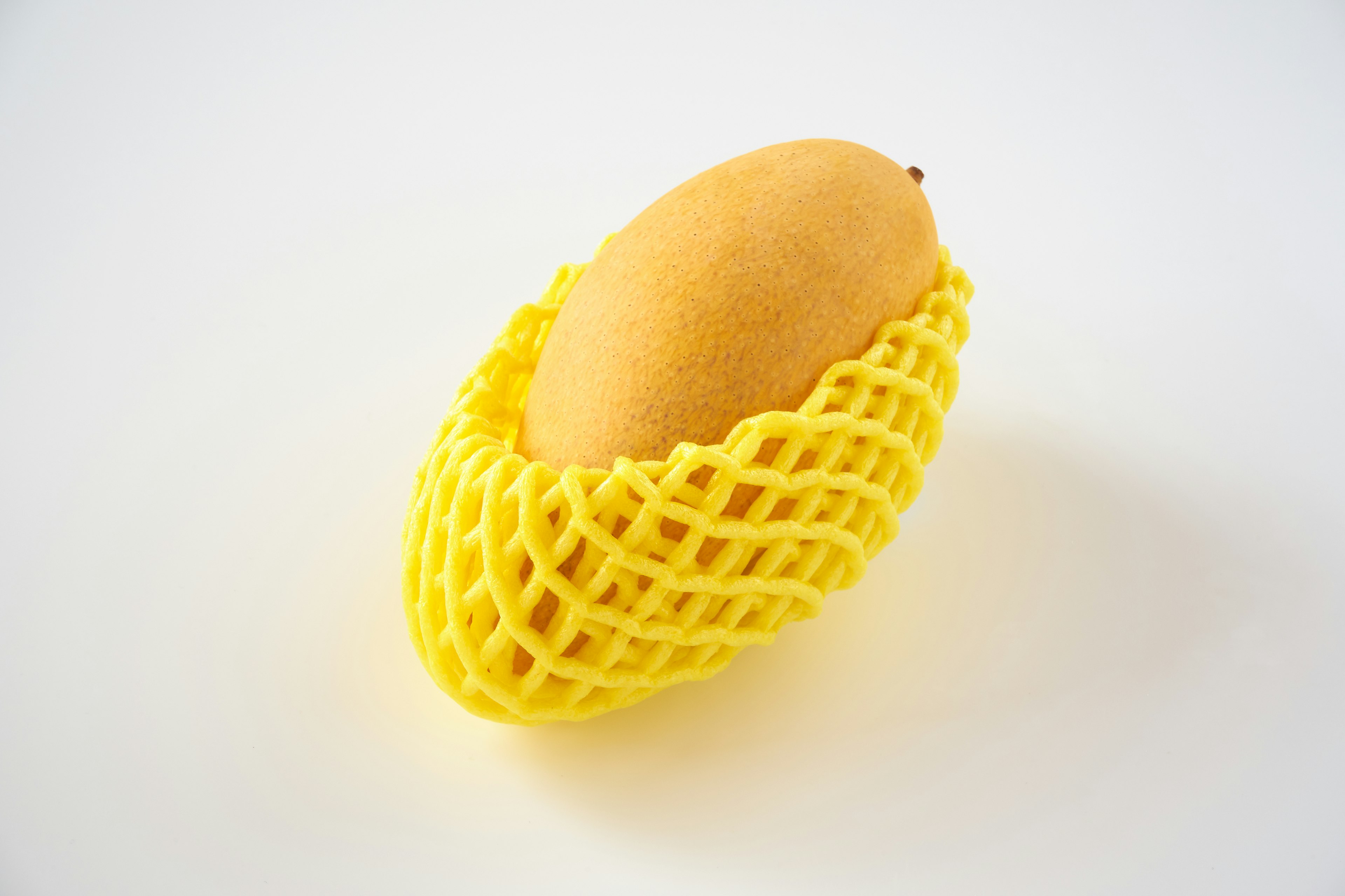 Mango wrapped in a yellow net