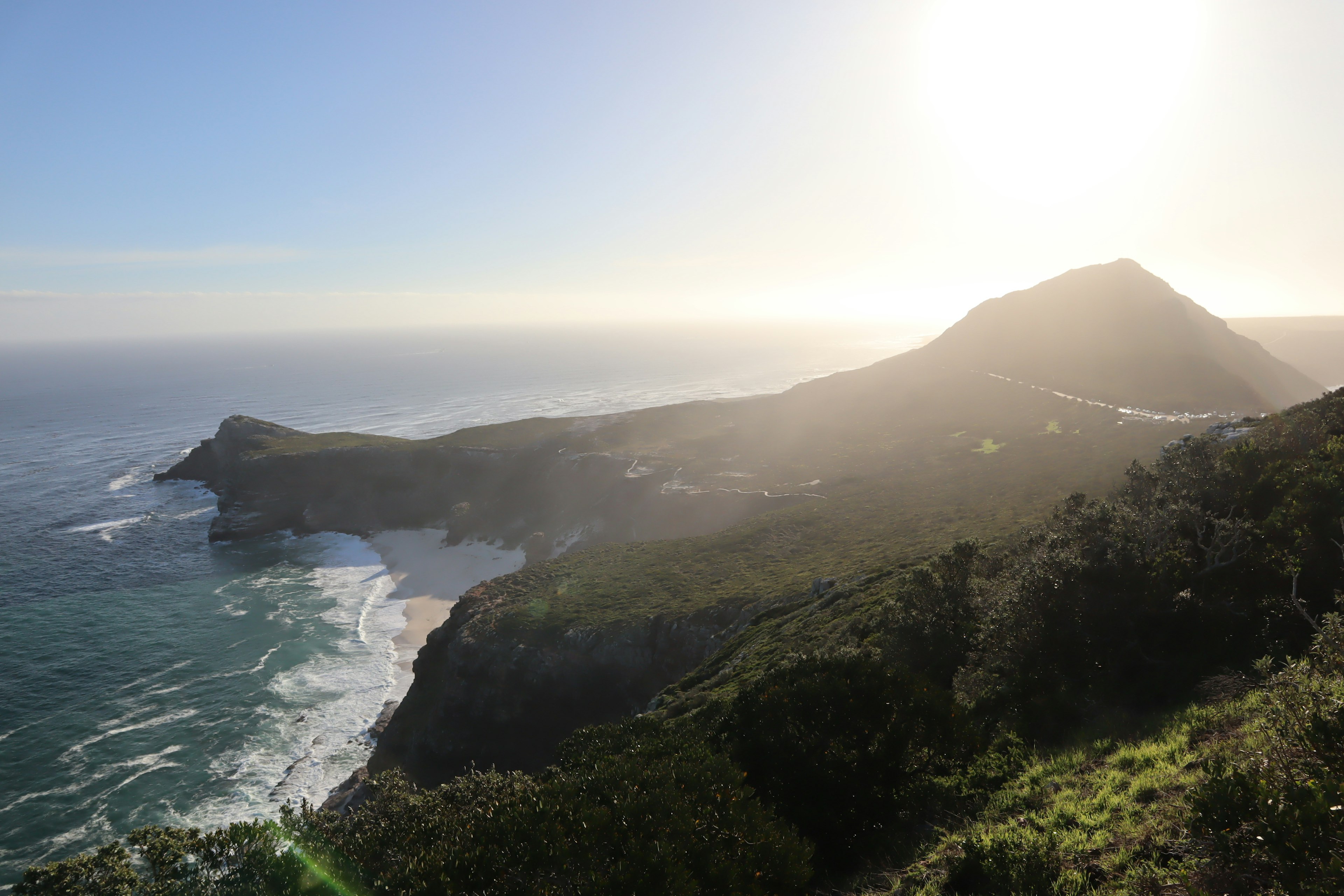 Coastal landscape with mountains and sunlight