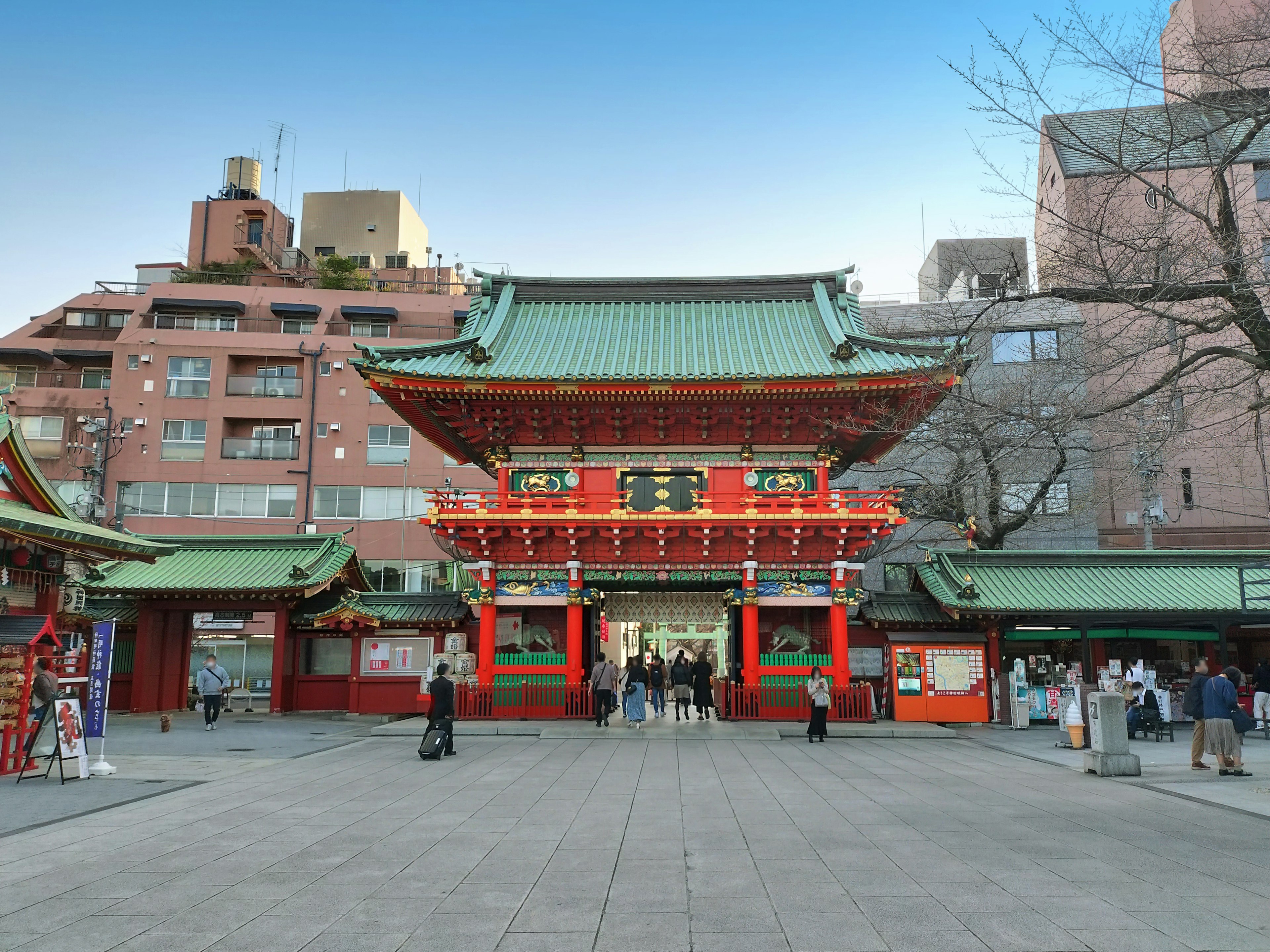 Colorful entrance of a Japanese shrine with surrounding buildings