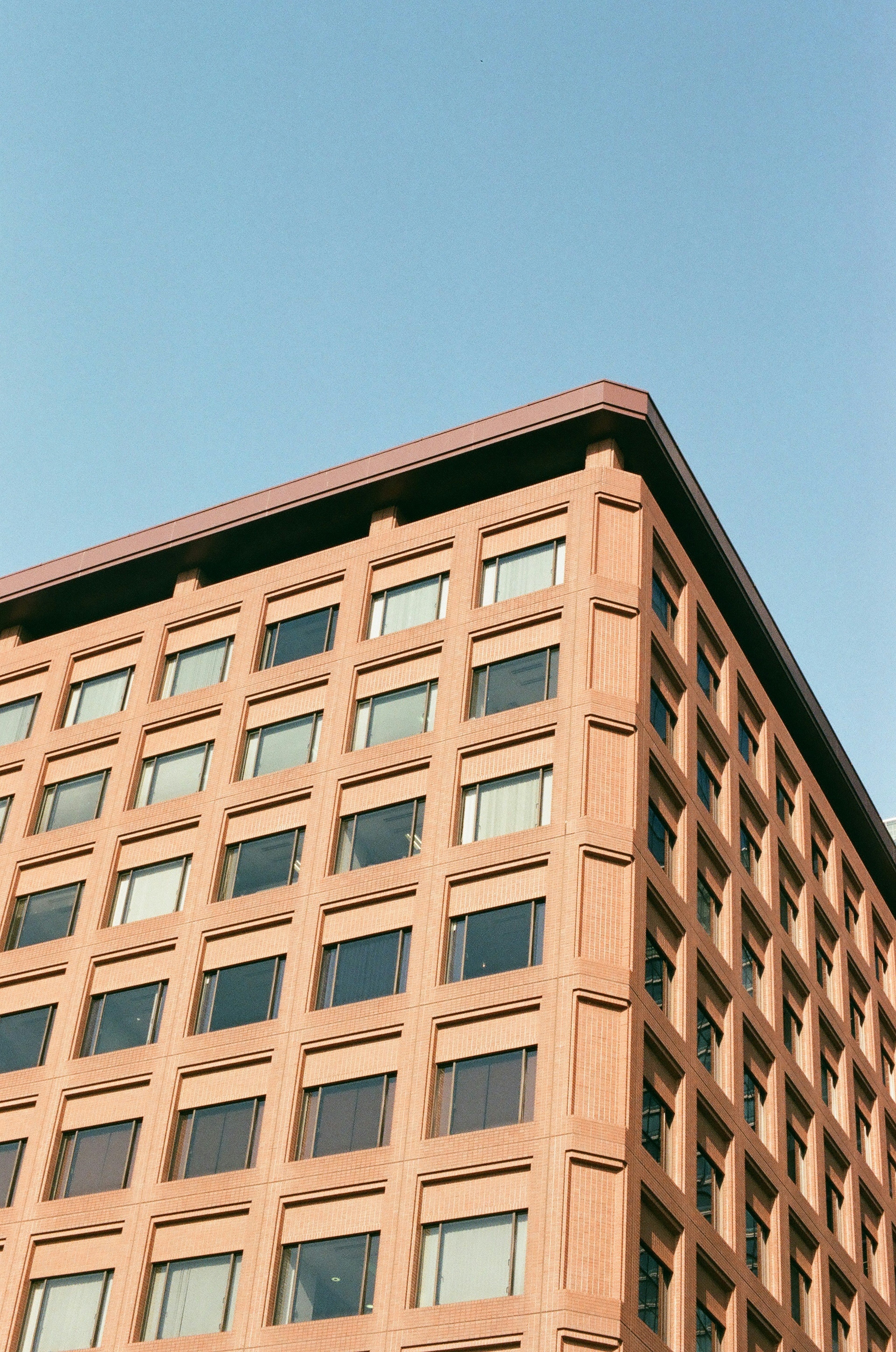 Upper part of a distinctive building under a clear blue sky