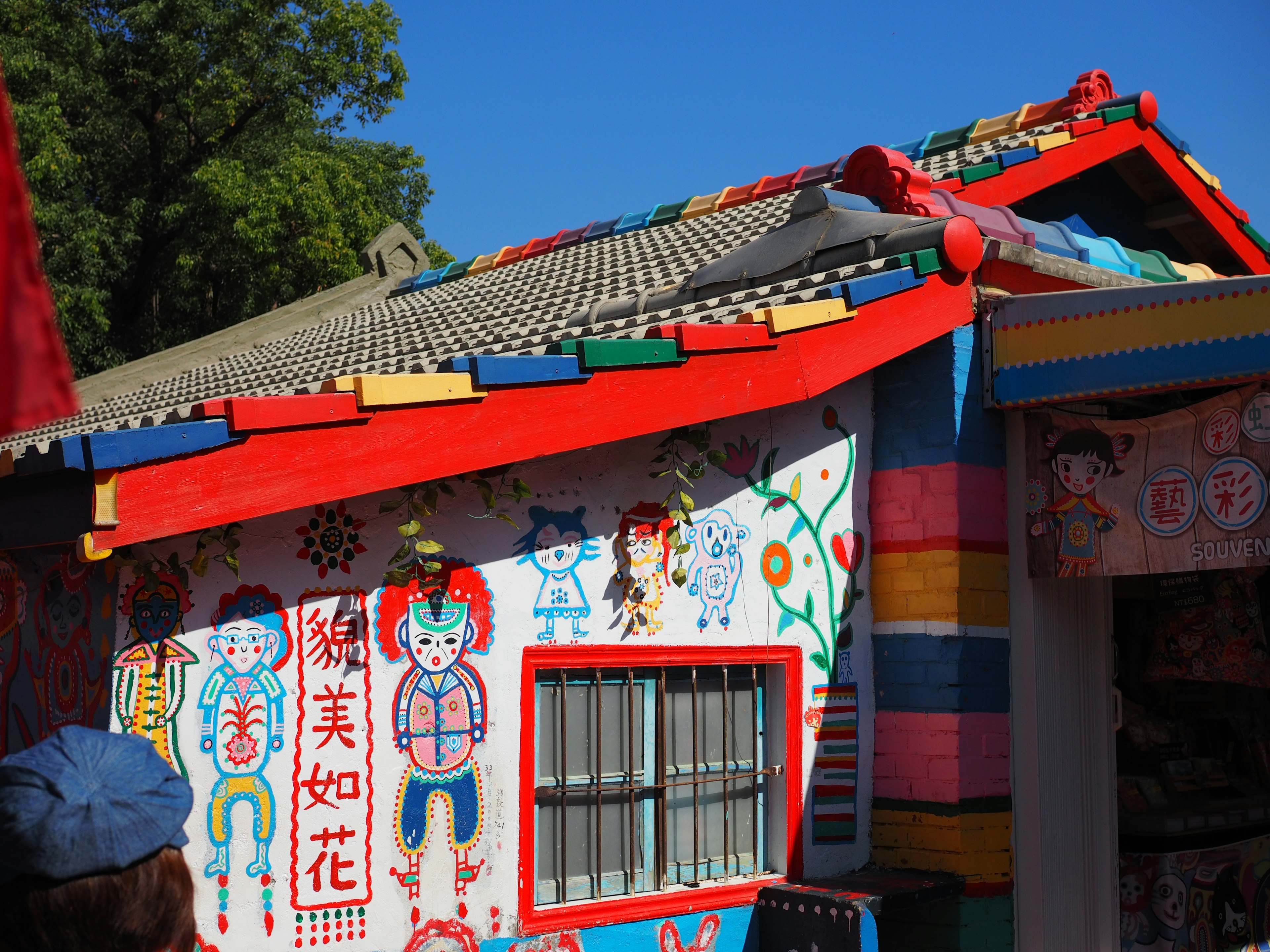 Cabaña colorida con murales vibrantes y un techo rojo