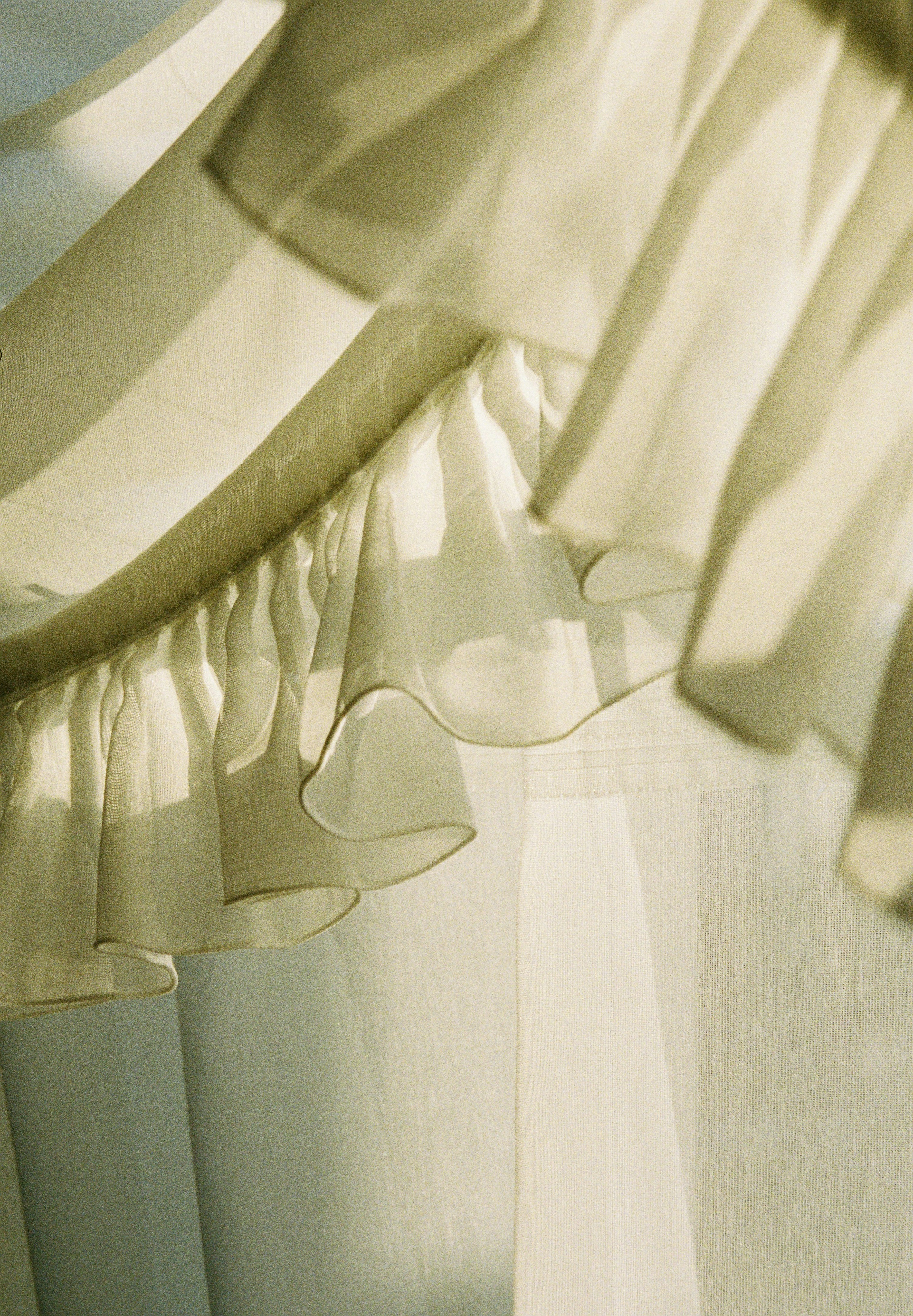 Close-up of a ruffled section of a sheer fabric dress