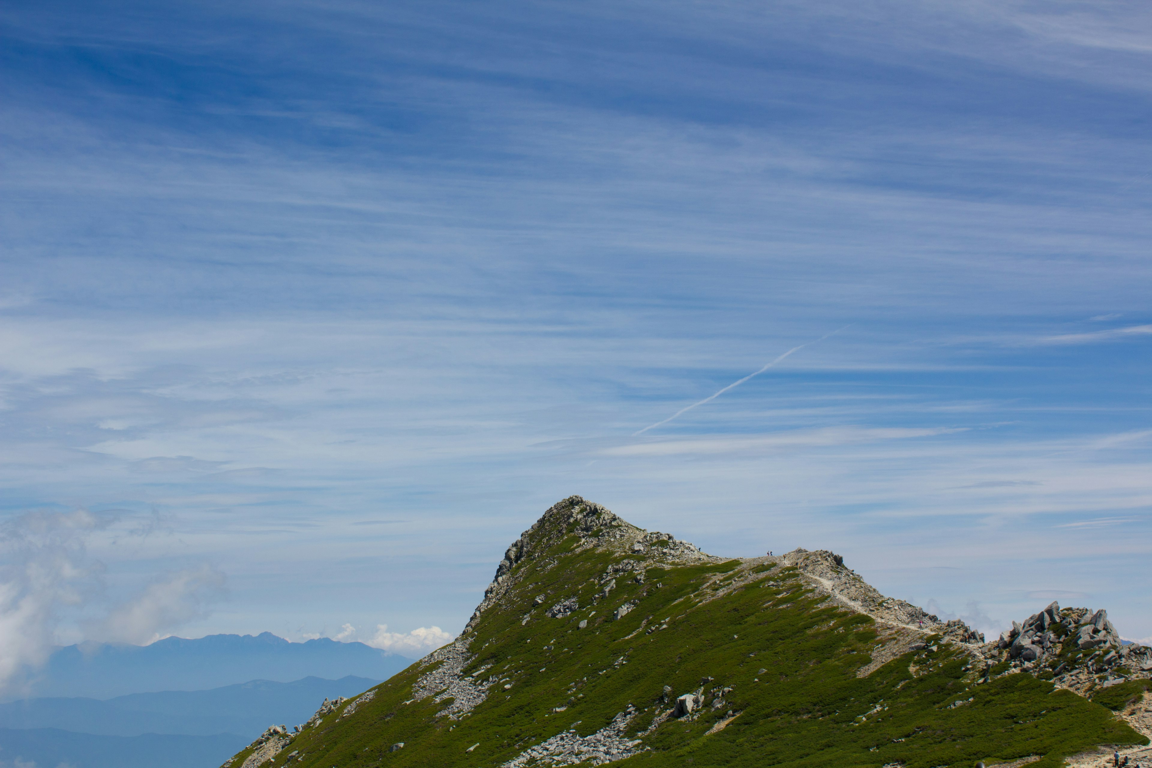 Scenic view of a mountain peak under a blue sky