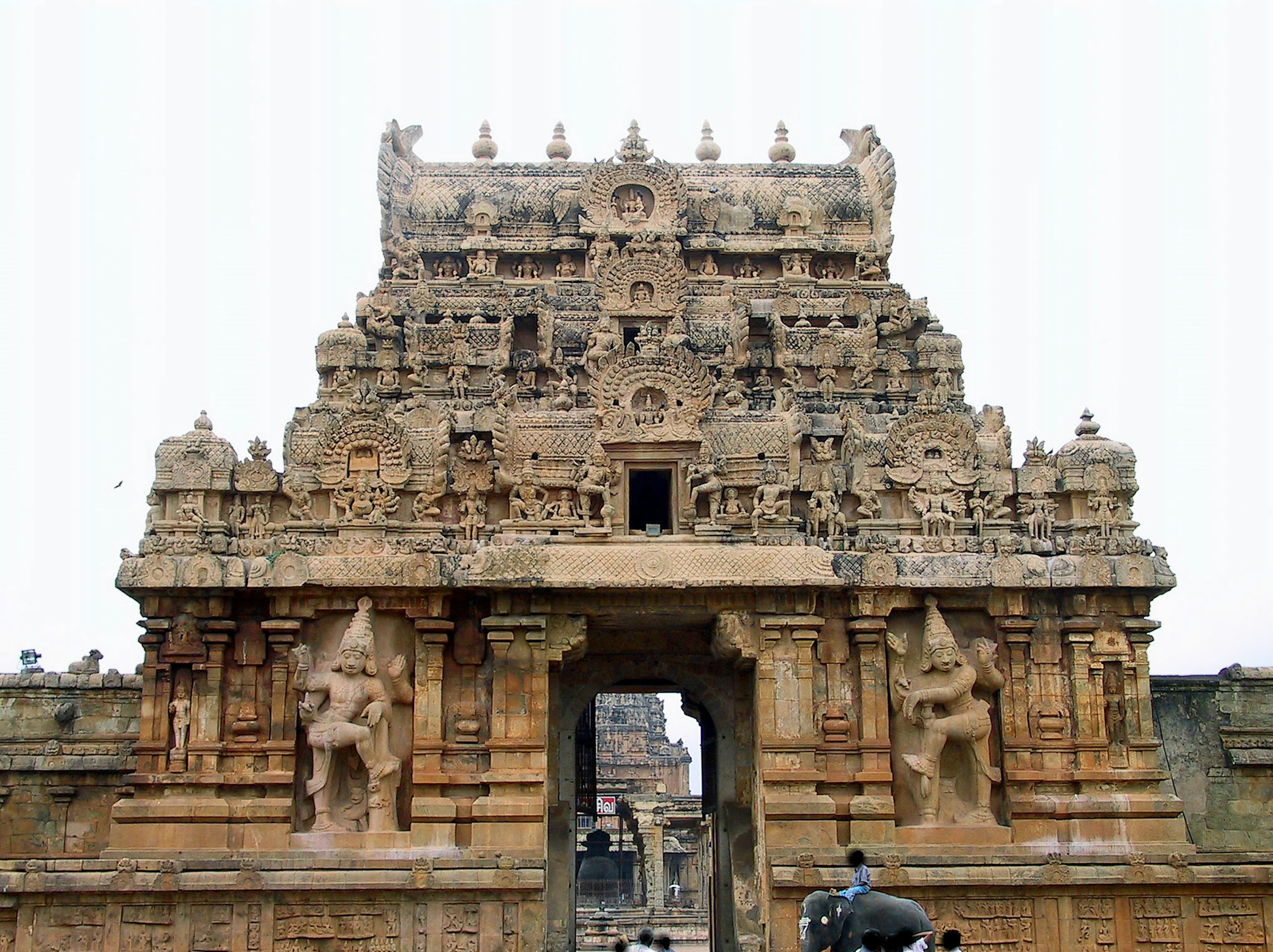 An ancient temple entrance featuring intricate carvings and sculptures