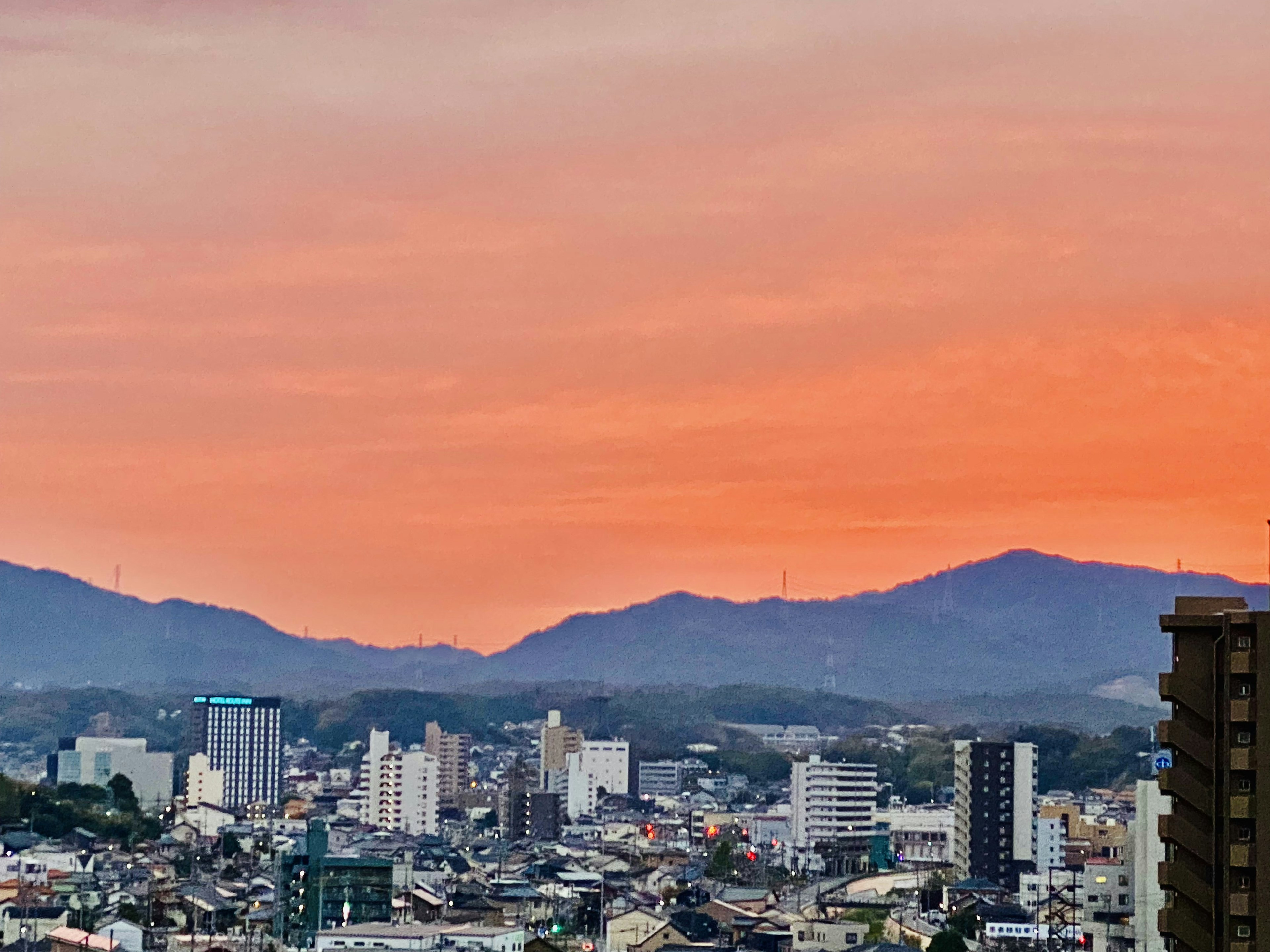 Urban landscape with an orange sunset sky in the background